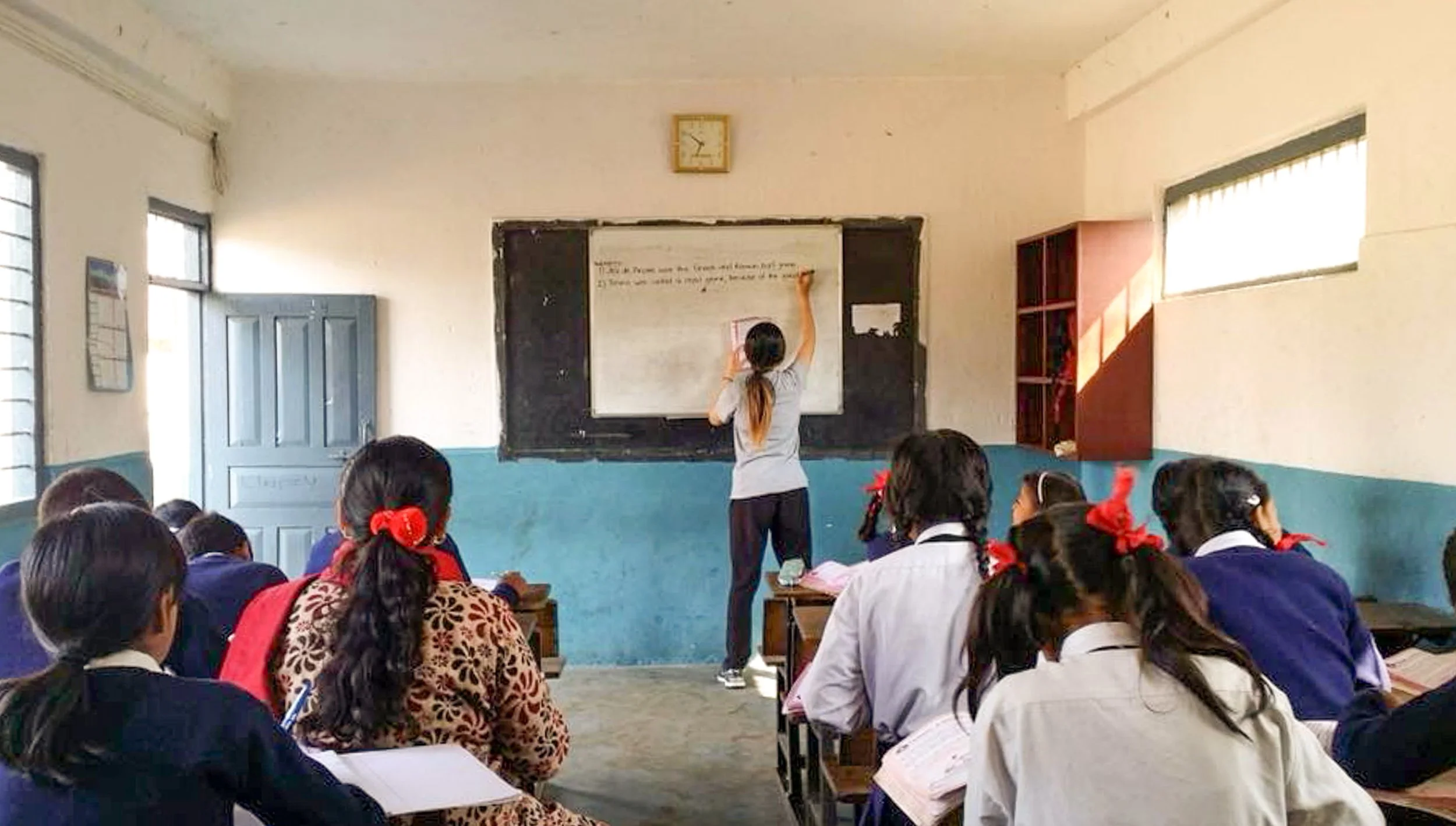 Teaching English classroom volunteer work in Nepal with local school students, humanitarian travel photography