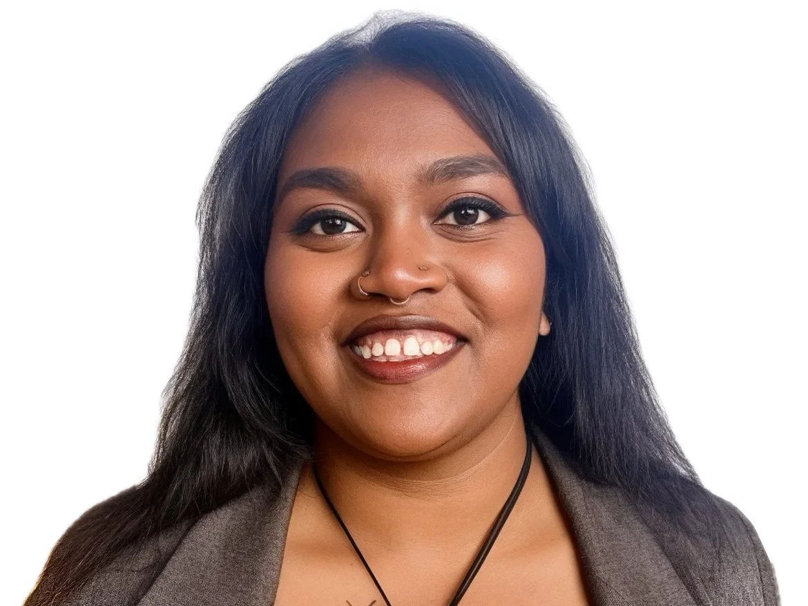 MLVS Team: Shalom Bandi, LTF Health Coordinator. Headshot of a young woman with long dark hair, brown skin, and a big smile, wearing a gray top and a black necklace against a white background.