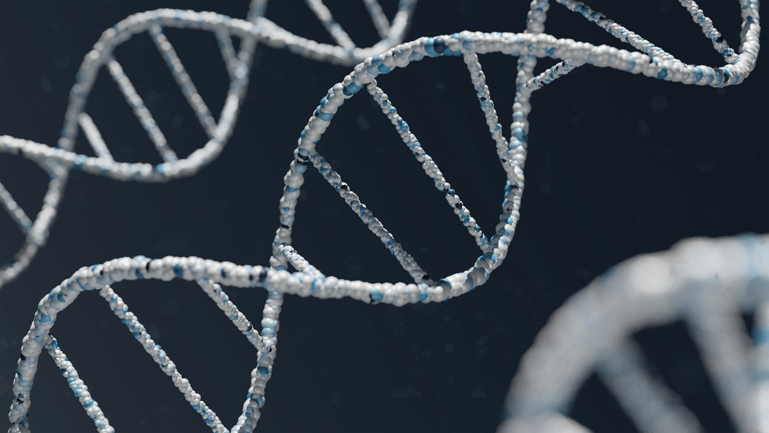 Close-up of DNA double helix strands with a dark background.
