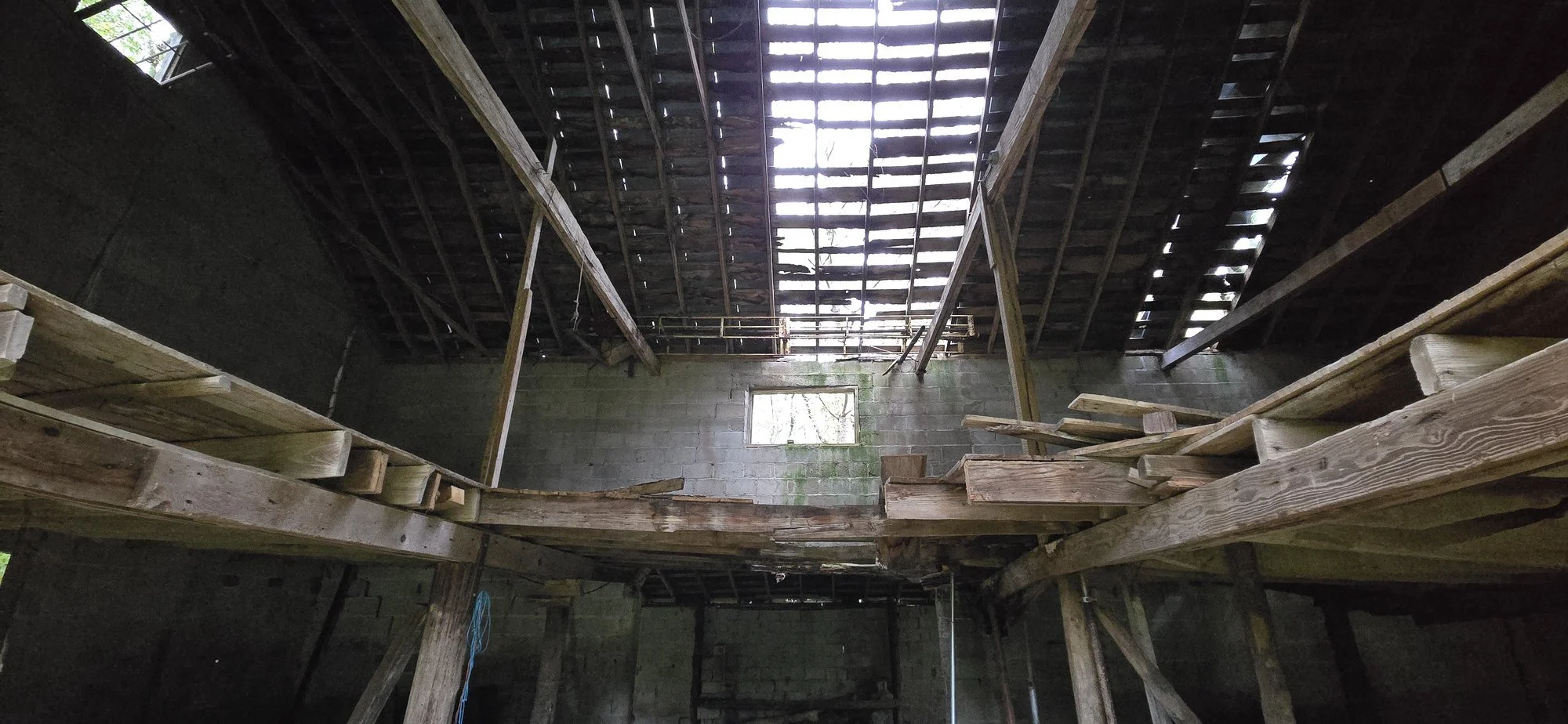  Inside the block barn, with the roof open to the sky. 