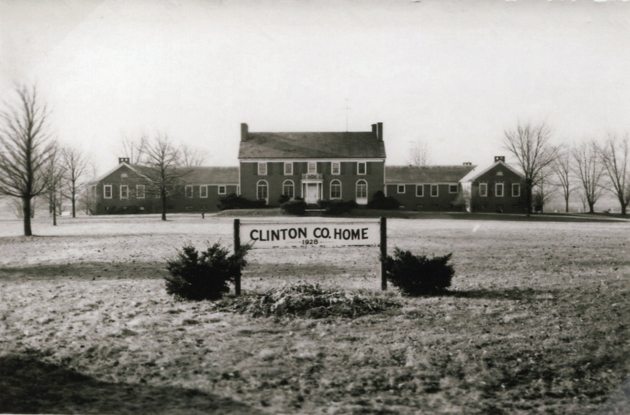 The 1929 Clinton County Home building, a one-story fireproof structure now known as Fife Hall, with the County Home sign in the foreground.