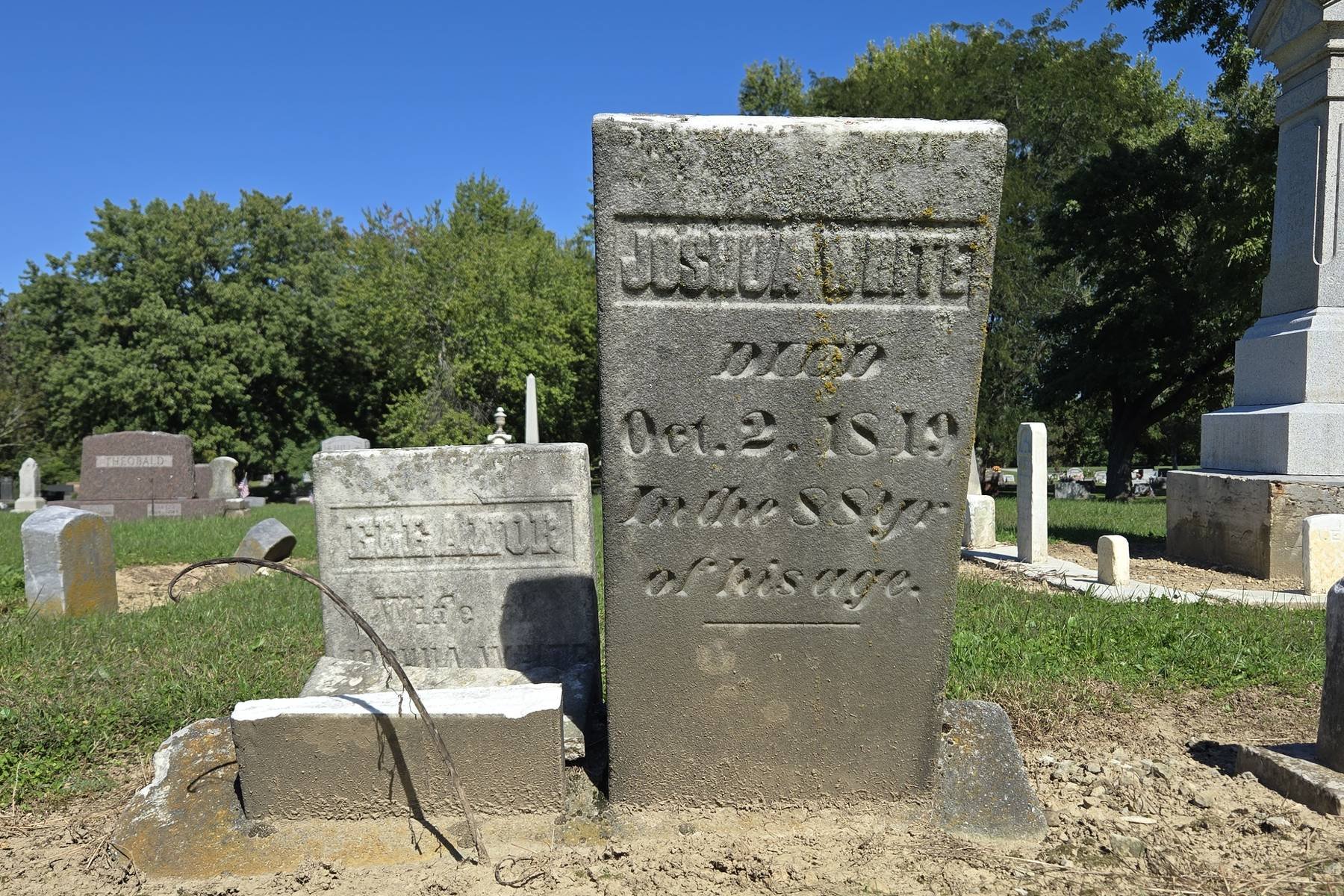 Weathered upright gravestone reading "Joshua White, died Oct. 2, 1849, in the 88 yr of his age," beside a smaller broken stone for "Eleanor, wife of Joshua White."
