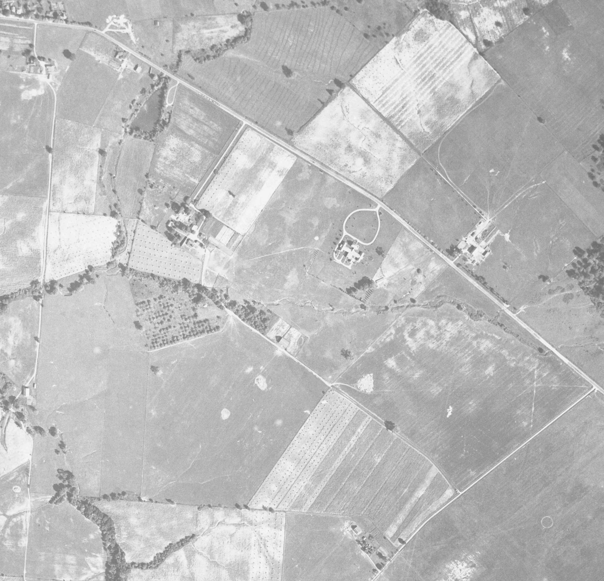 1938 aerial photograph of the Clinton County Infirmary farm, showing the grid of the orchard beside Lytle Creek.