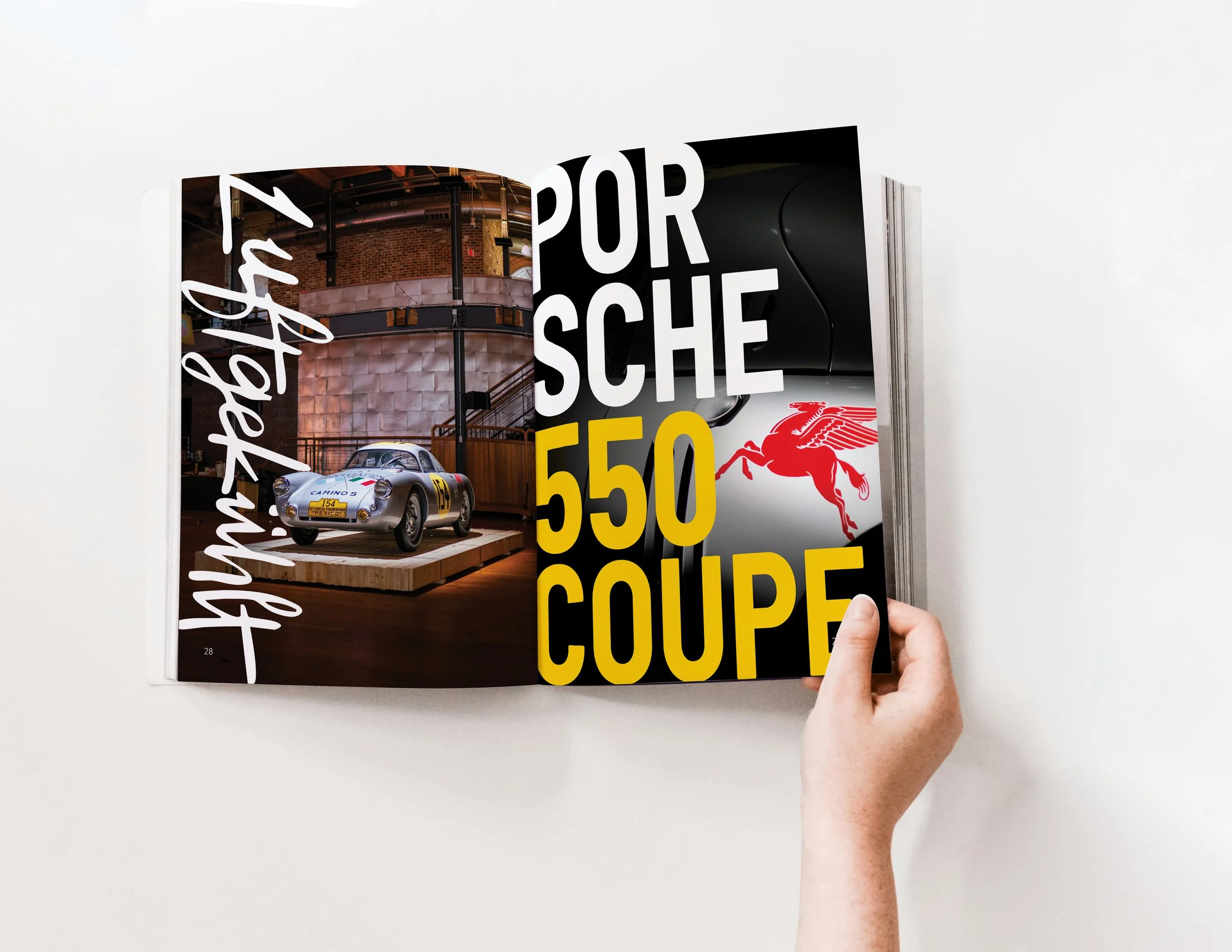 Open magazine showing a vintage race car on a wooden platform and bold text about Porsche 550 Coupé with a red Pegasus logo.