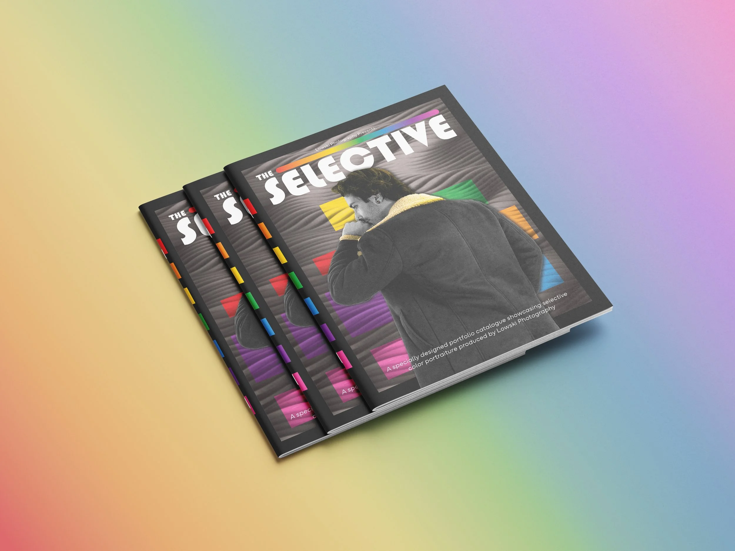 Three copies of a magazine with a colorful cover design, showing a person wearing a jacket on the front, placed on a rainbow-colored background.