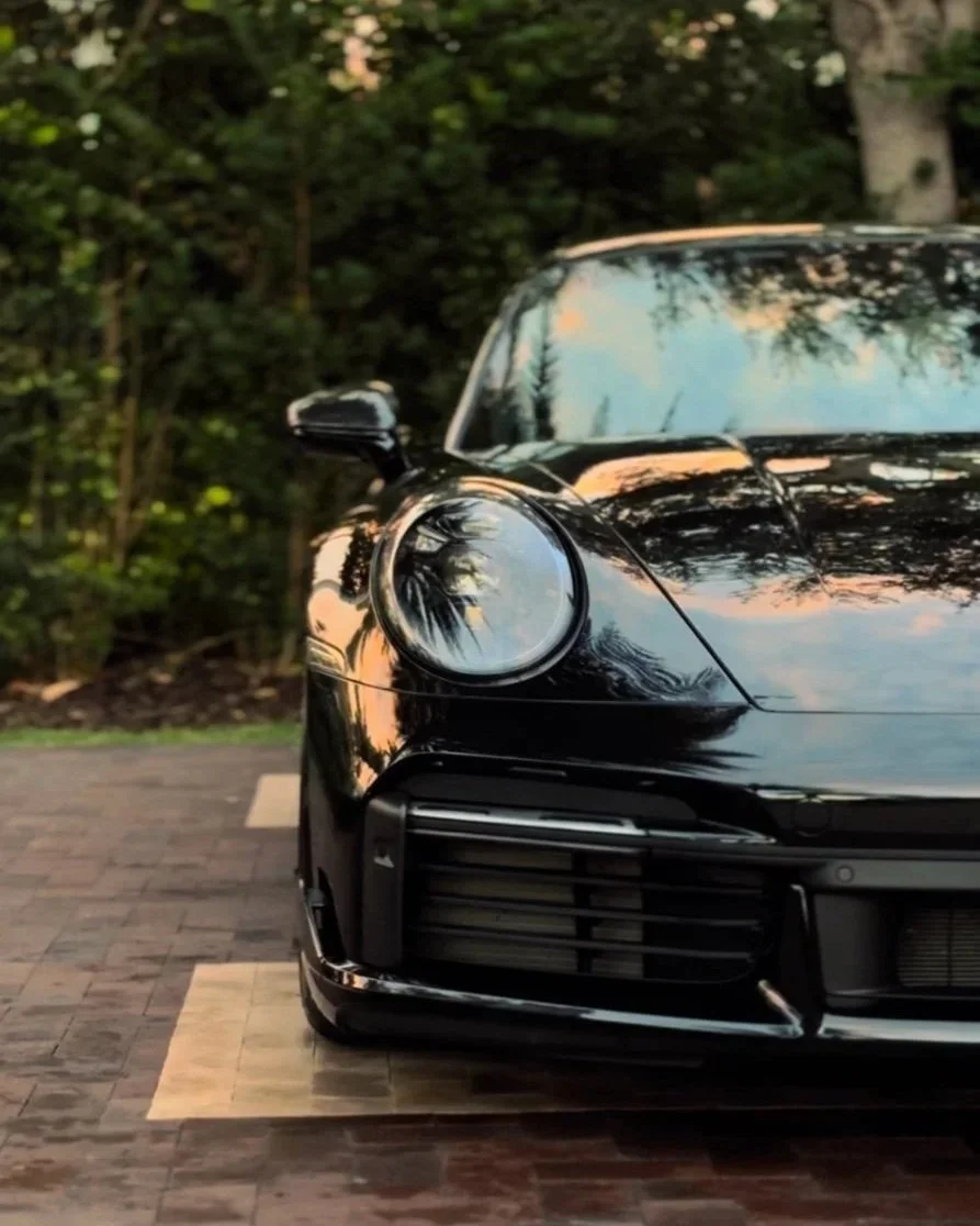 Black Porsche 911 front end after exterior detailing in Naples Florida