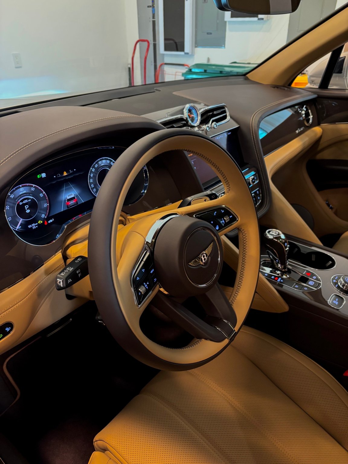 Close-up of Bentley steering wheel and center console following interior detailing maintenance