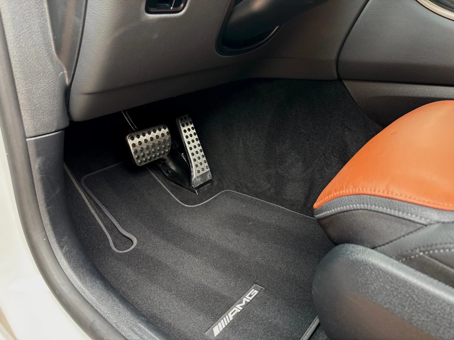 Mercedes AMG driver floor mat after professional interior detailing with restored carpet finish in Naples FL