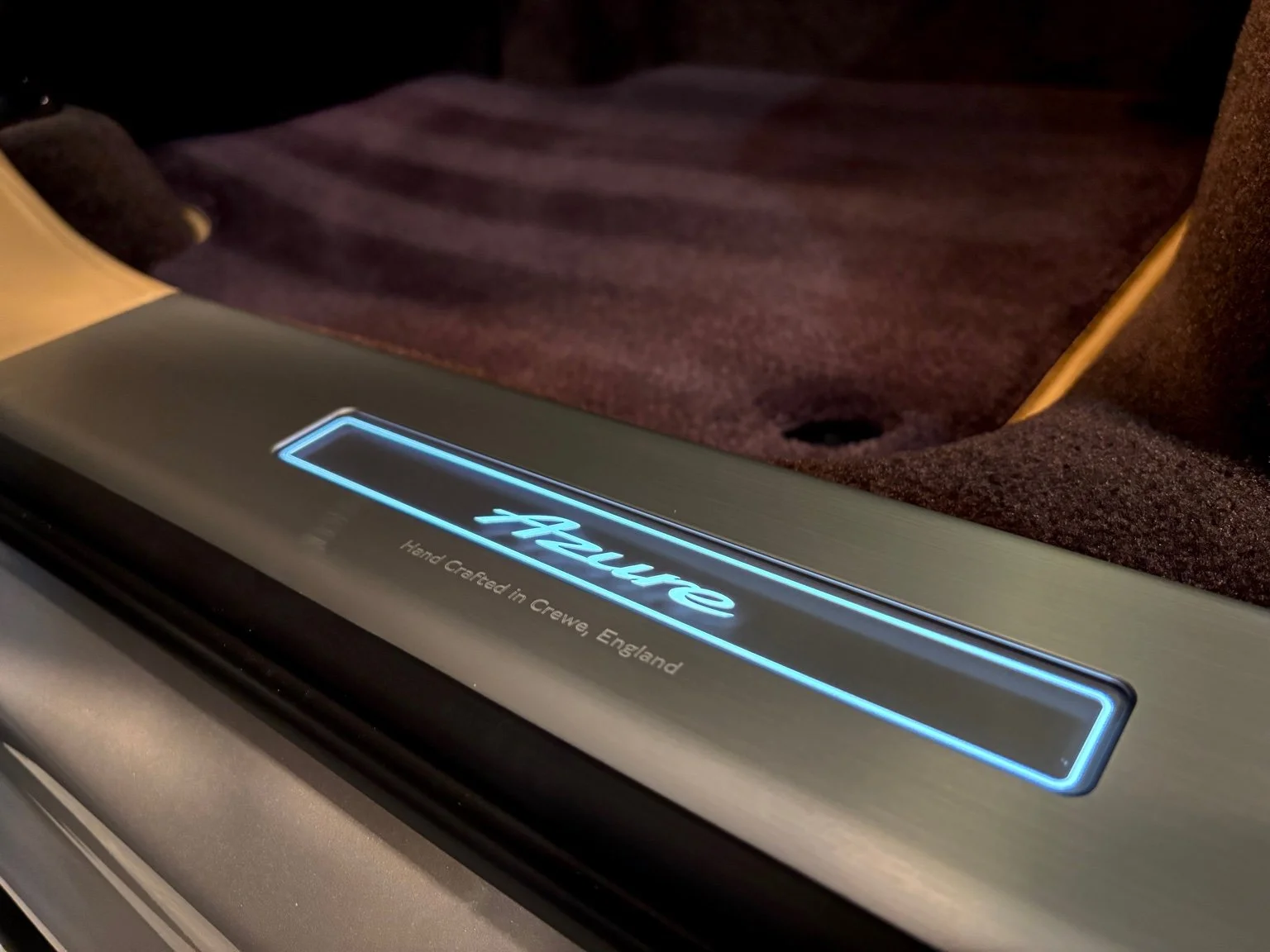 Illuminated Bentley Azure door sill plate during interior maintenance service