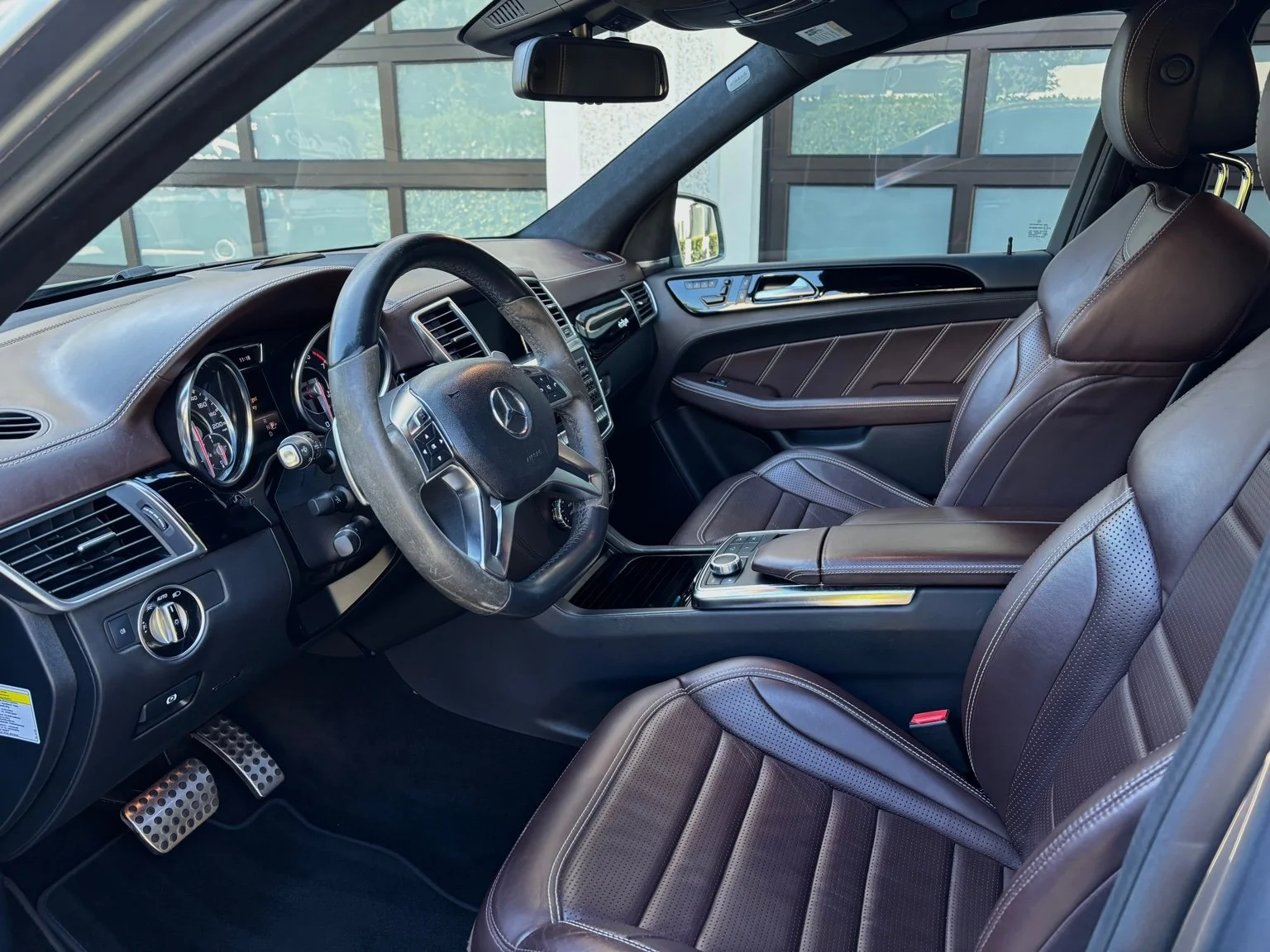 Front interior after mobile car detailing service in North Naples FL featuring cleaned leather seats and center console