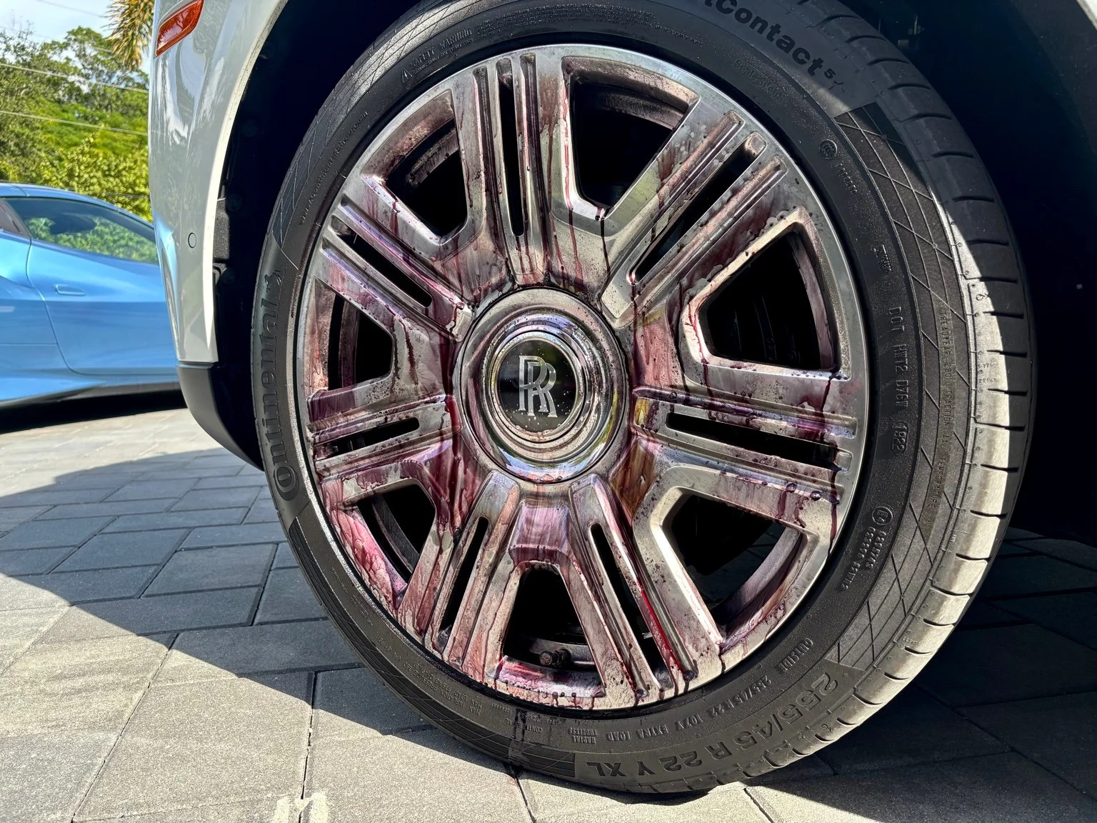 Rolls-Royce wheel undergoing iron decontamination with heavy brake dust bleed at BFA Detailing Naples FL