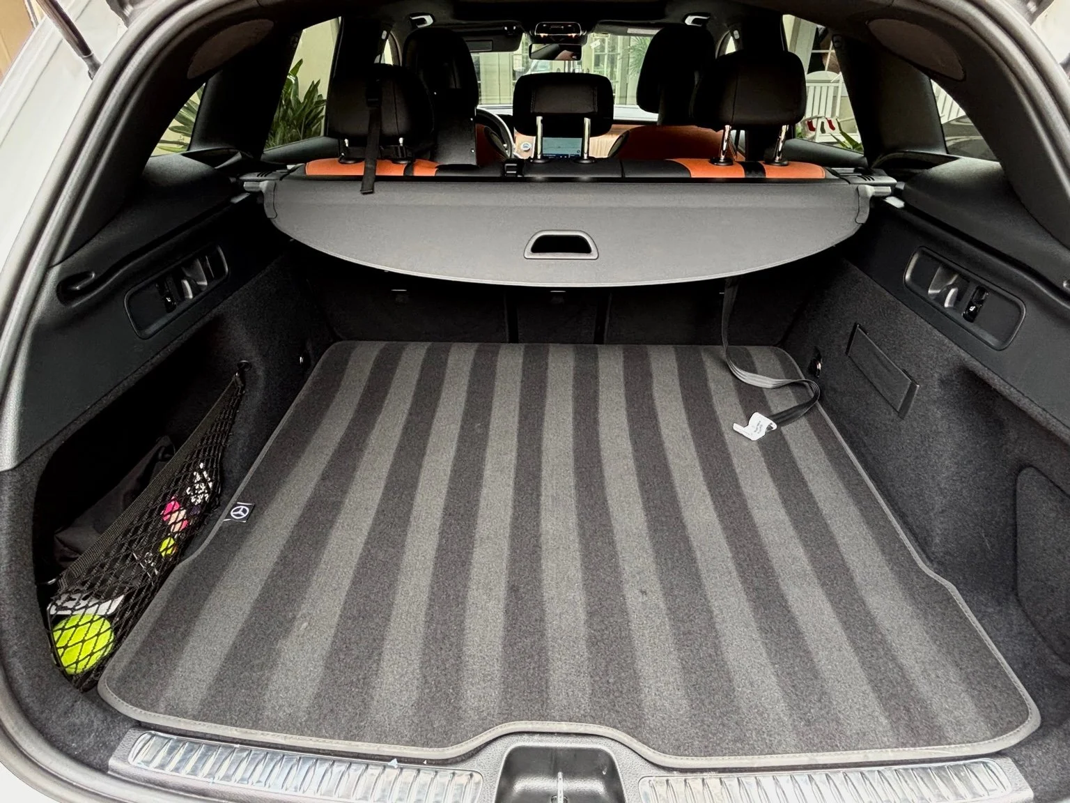 Mercedes AMG trunk after interior detailing service in Naples FL with fully cleaned cargo mat and vacuumed carpet lines