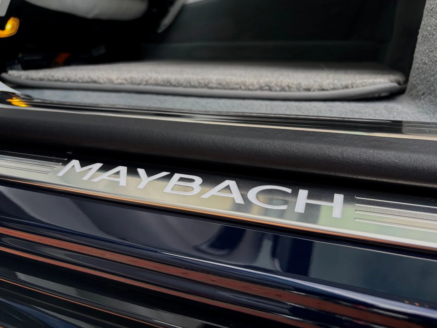 Maybach illuminated door sill cleaned during full interior detailing service in North Naples FL