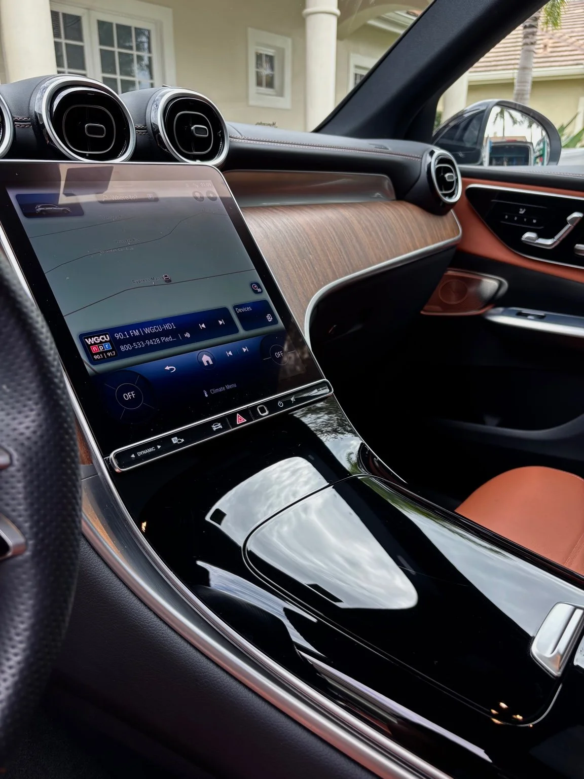 Luxury SUV center console after interior detailing with clean glossy trim and spotless display in Naples FL