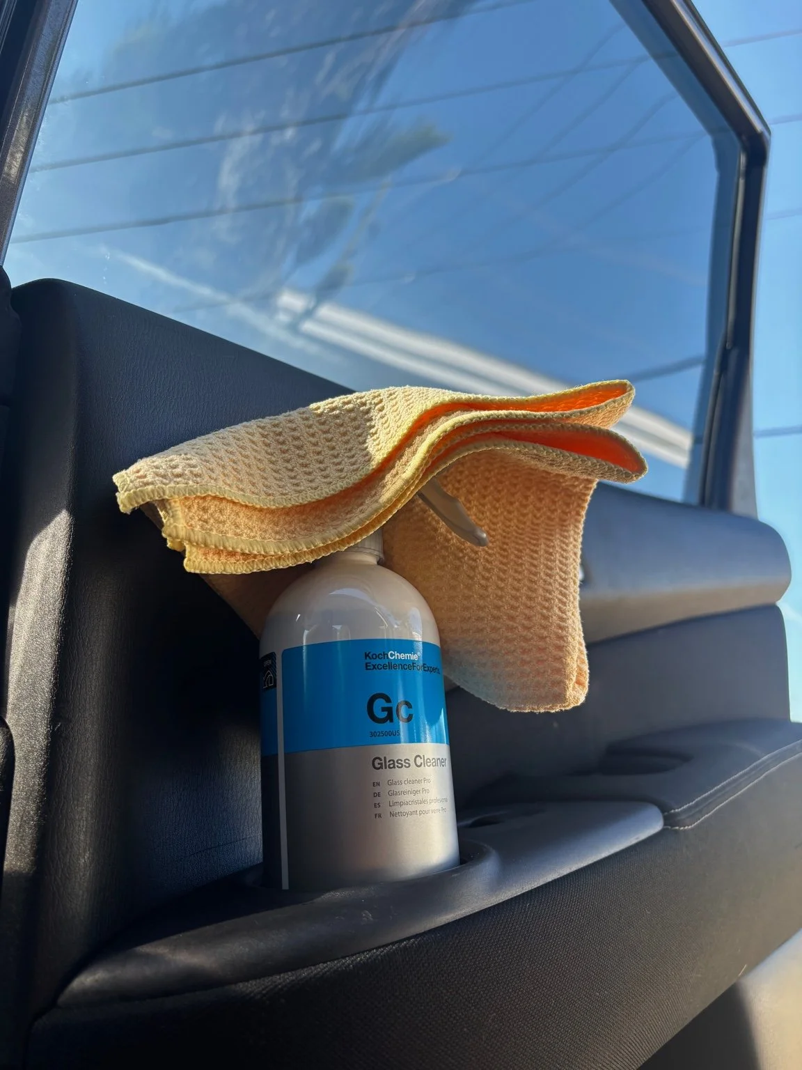 Professional auto glass cleaner and microfiber towels used for streak free window detailing in Palm Beach.