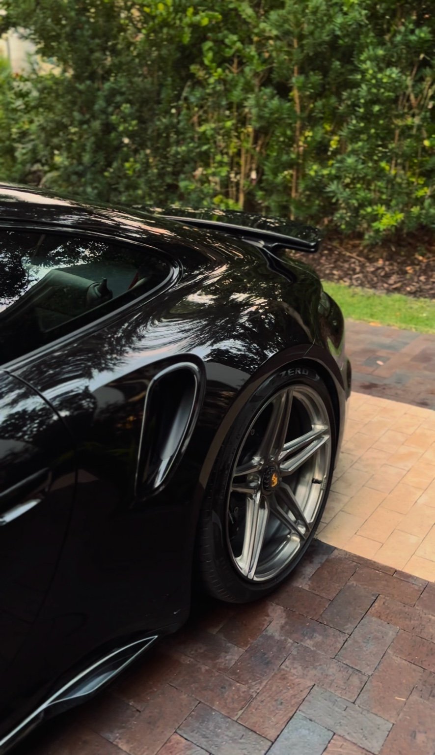 Porsche 911 rear quarter panel and wheel after premium car detailing in Naples FL