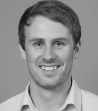 Black and white portrait of Nic Robin with short hair, wearing a collared shirt.