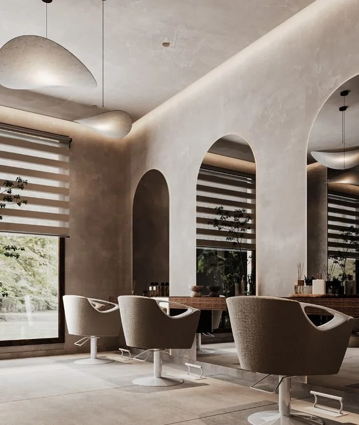 Modern interior space with beige swivel chairs, large arched openings, and minimalistic decor.