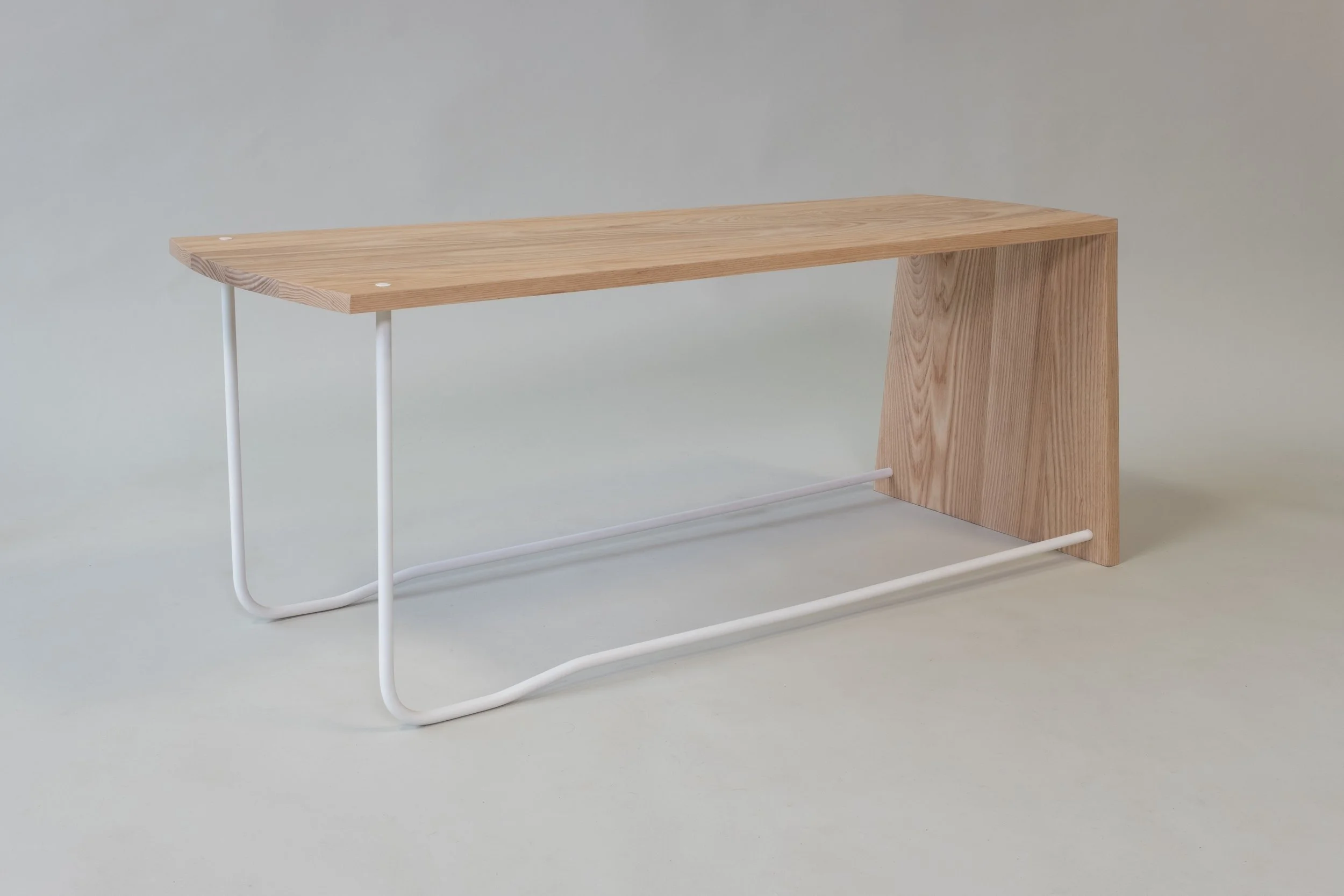 Modern wooden and metal bench with a curved wooden seat, a metal frame, and a rectangular wooden support on one side.