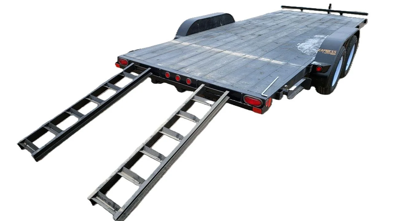 A flatbed trailer with two ramps extended for loading, parked on a white background.