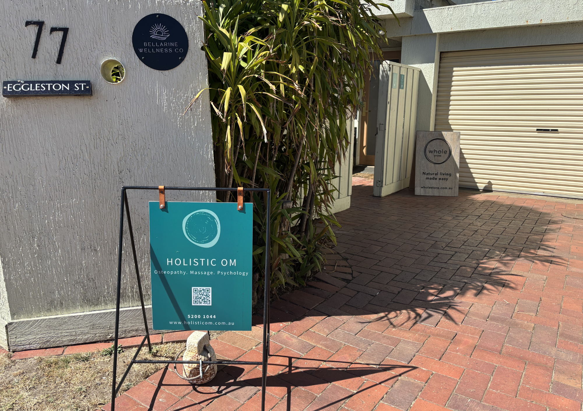 Entrance to the Holistic OM Ocean Grove Clinic with A frame sign and 77 Eggleston st, Ocean Grove