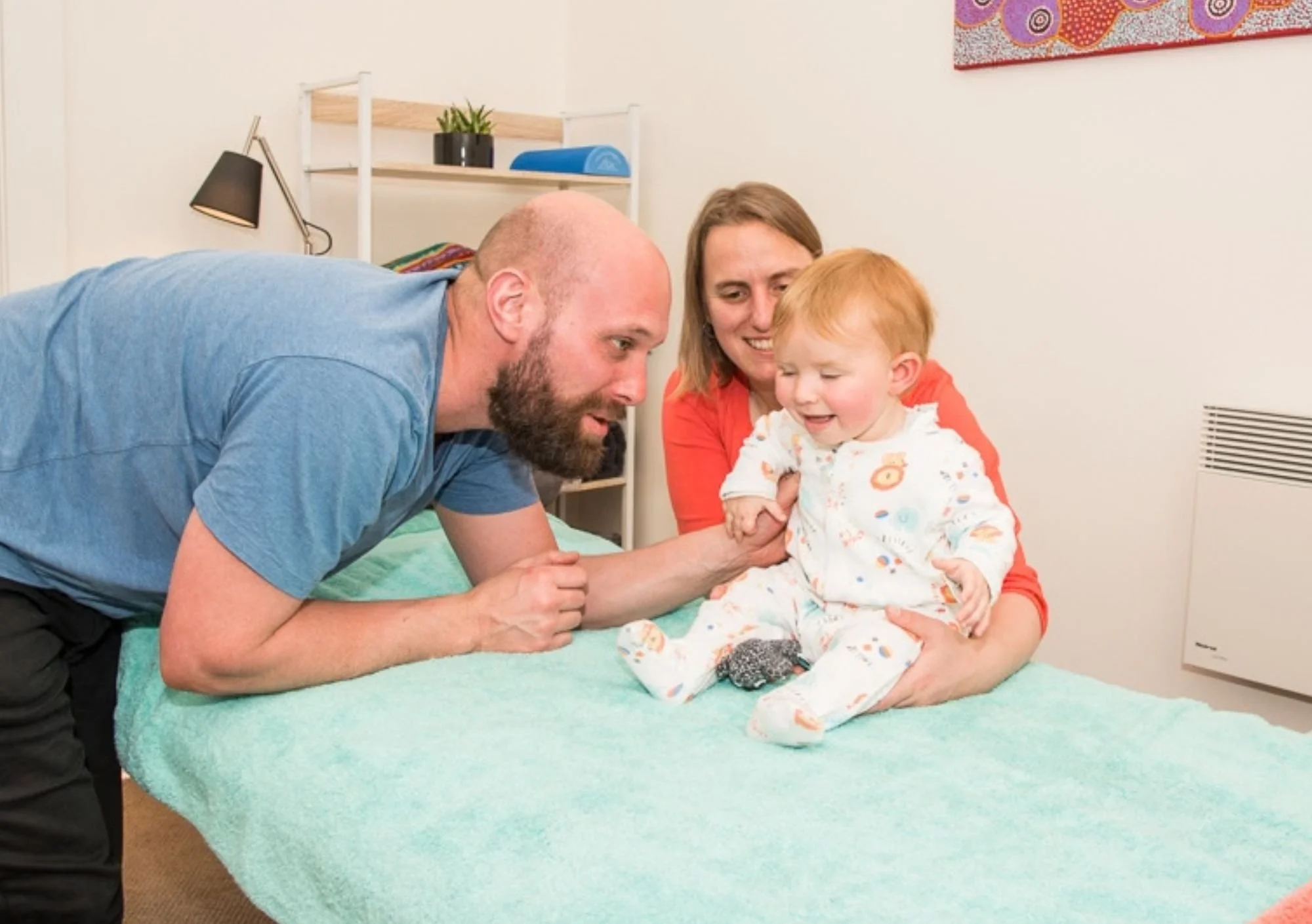 Dad with baby on table having a treatment
