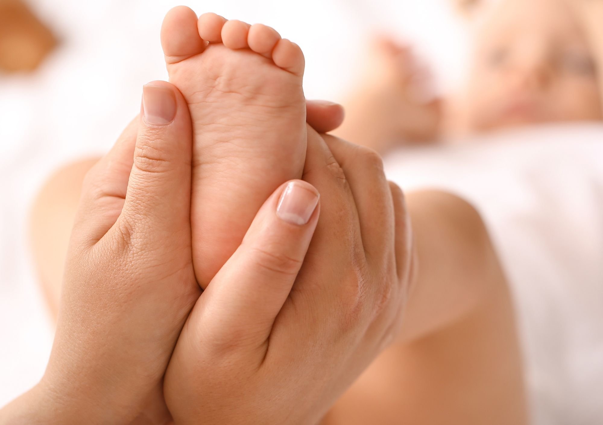 infant foot being massaged