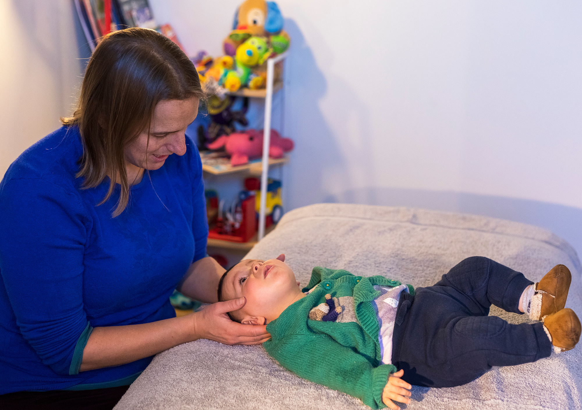 Cranial osteopath treating babies head