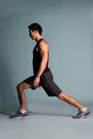 Man performing a lunging exercise in workout attire