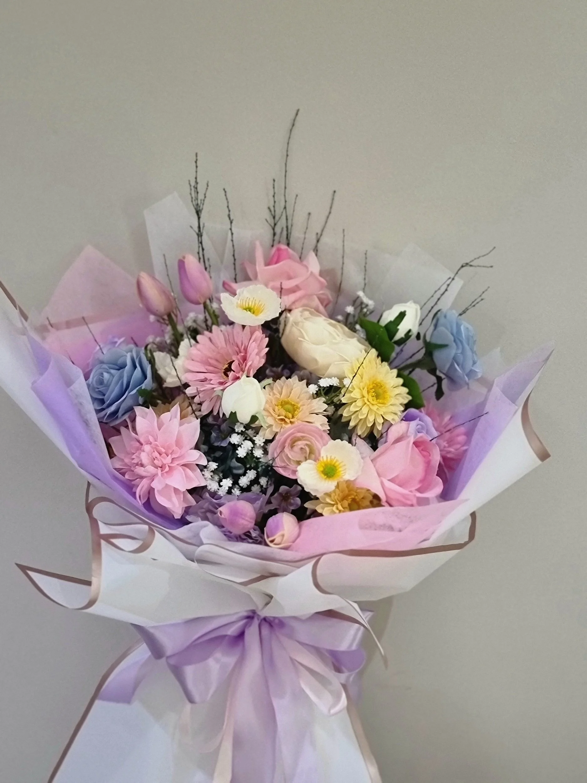 This bouquet is made with premium quality artificial flowers, blending with soft pastel colours.