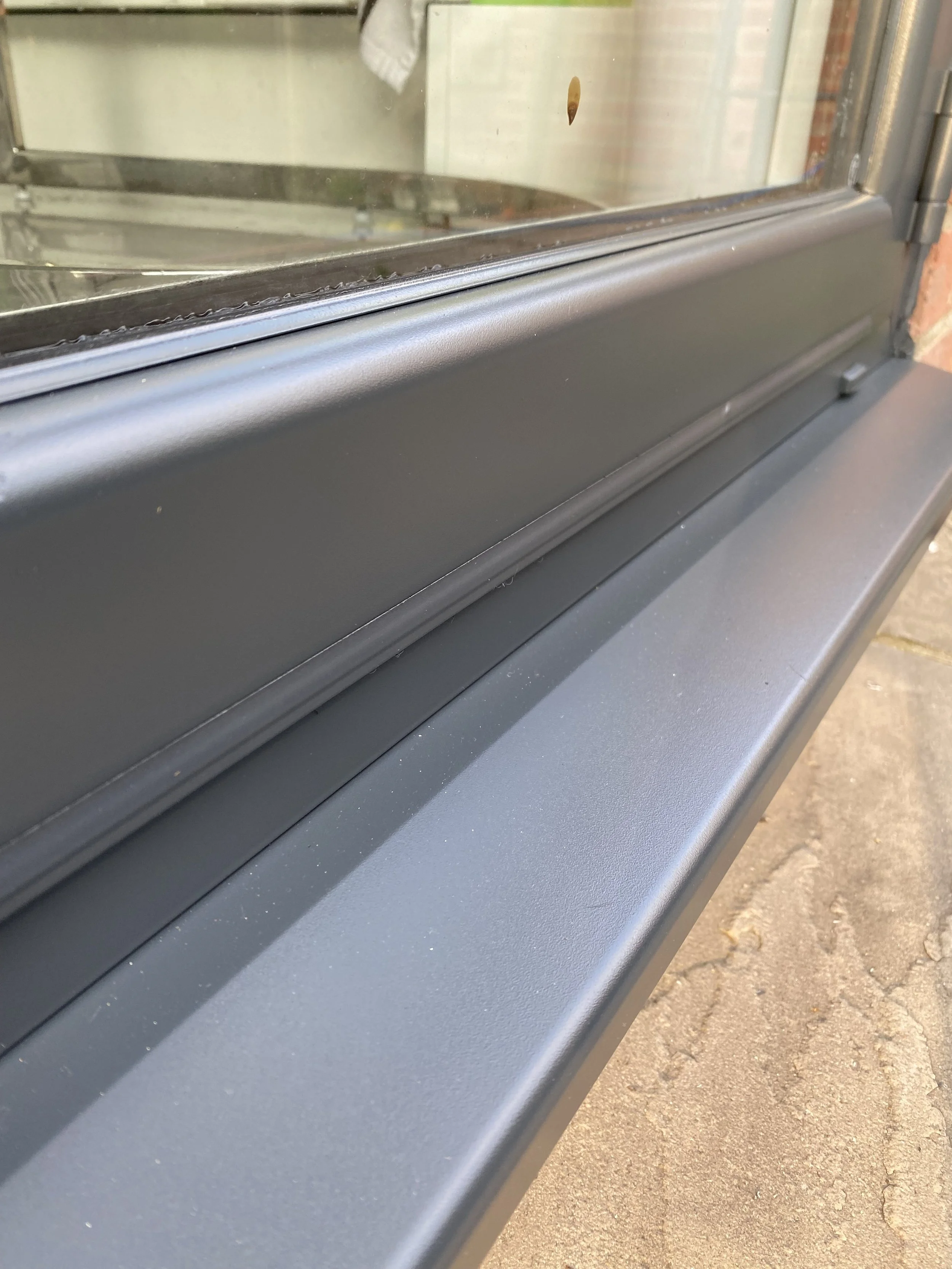 Finished grey UPVC window with professional spray finish by CLX Coatings