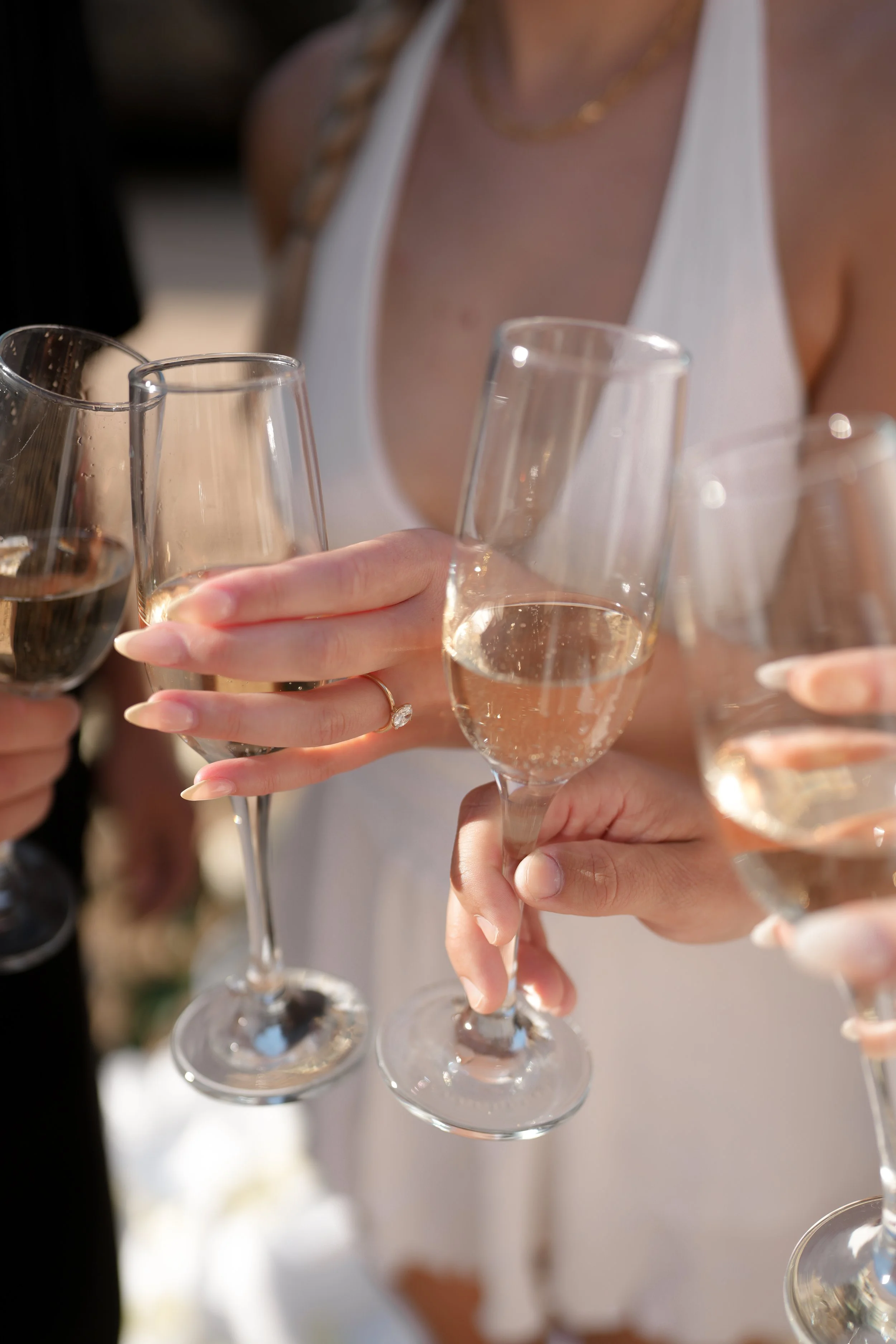 People clinking glasses of champagne at a celebration or gathering.