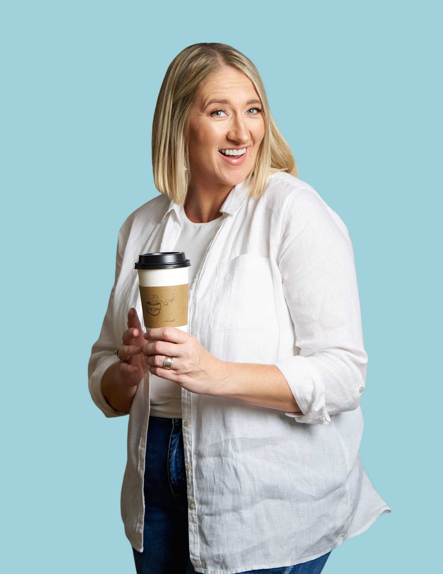 “Sara McMillan, Kansas brand photographer, holding a coffee cup at Local Five Lions café.