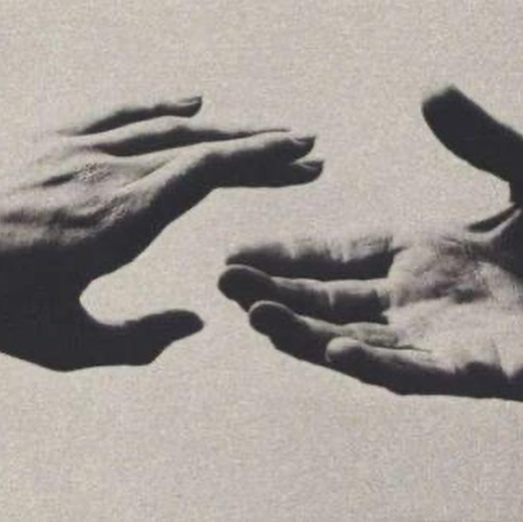 Two black and white images of hands reaching towards each other, creating a visual illusion of overlapping shadows.
