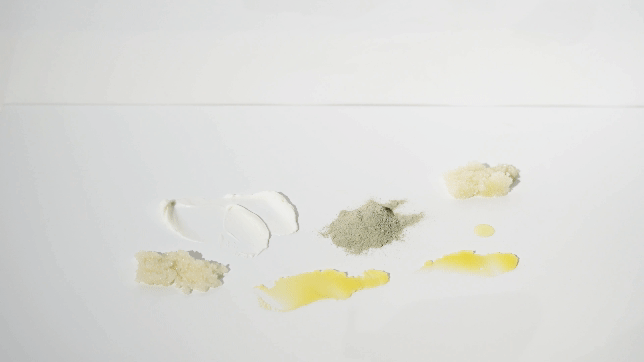 Various cooking ingredients and utensils on a white surface, including flour, sugar, lemon juice, and a spoon.