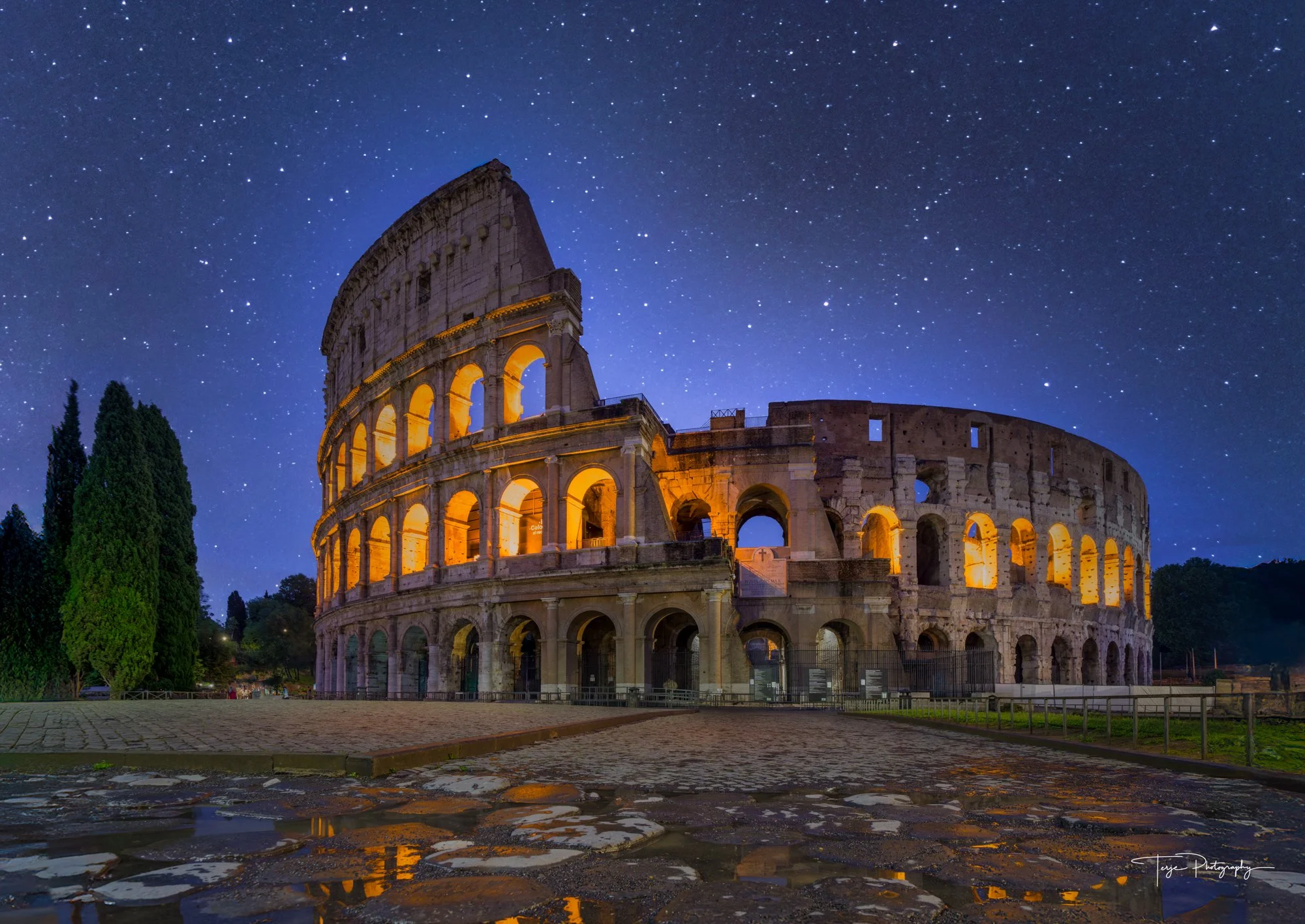 Colosseum in Rome at night with balanced exposure from bracketing and starry sky.