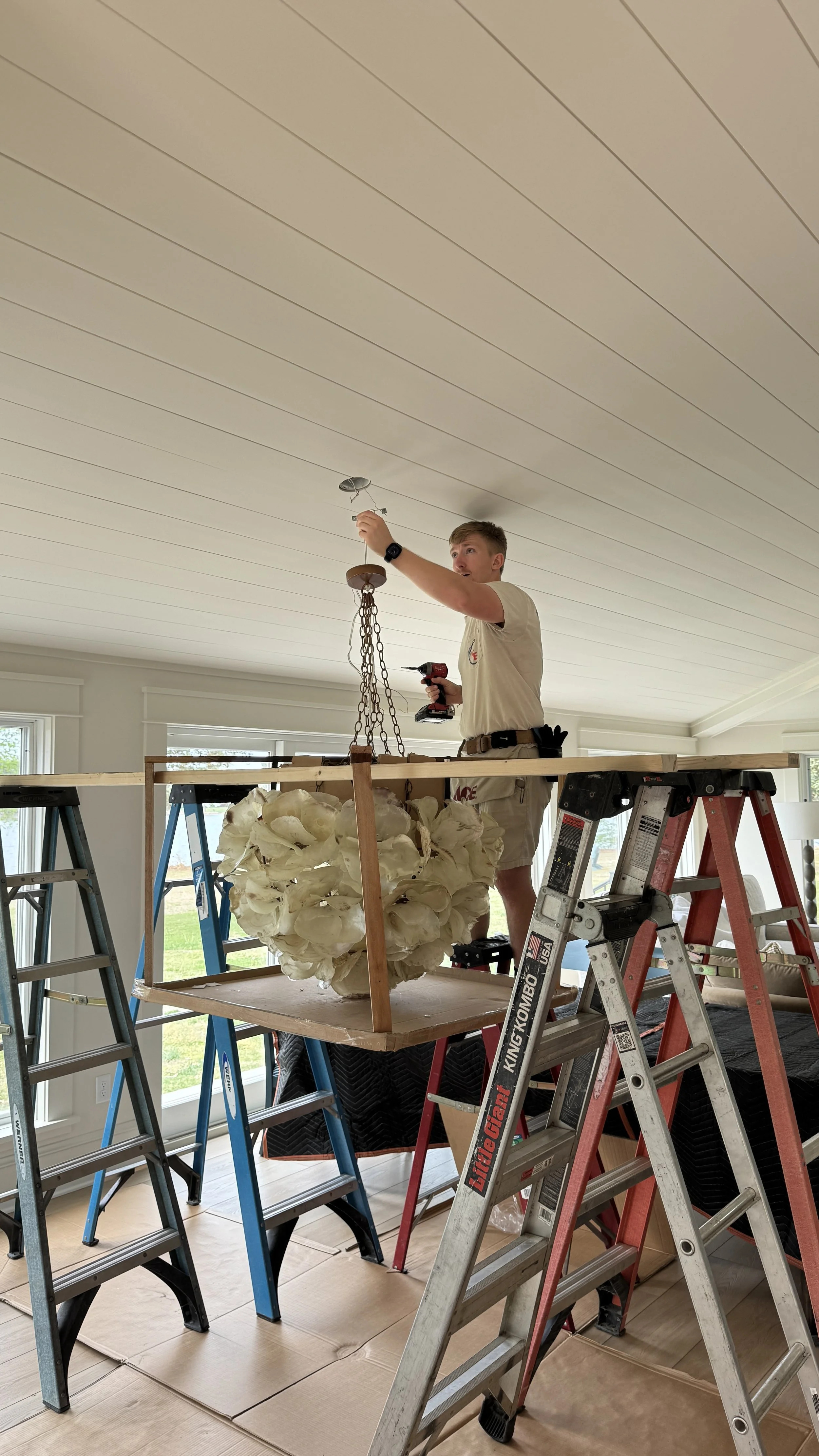 Complex & Custom Fixture Installation
No project is too complex or delicate for our team. Here, we utilize custom staging and precise rigging techniques to safely install an intricate, heavy statement chandelier onto a beautiful shiplap ceiling.