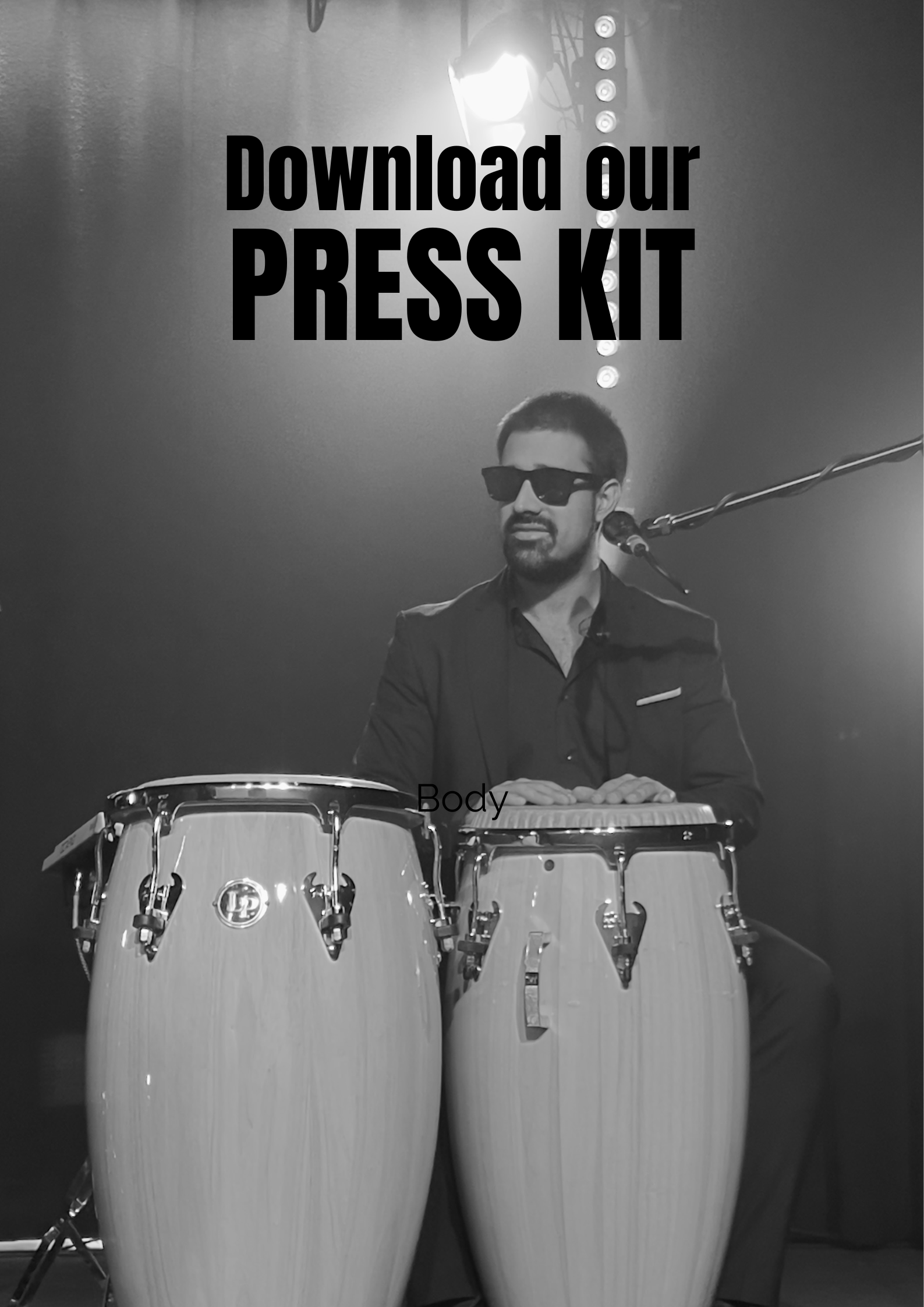 A man wearing sunglasses and a dark suit playing conga drums on stage with a microphone in front of him, black and white photo. Text overlay says 'Download our PRESS KIT'. Download Guacamaya Latin Band Press Kit. Latin Band based in the north west UK
