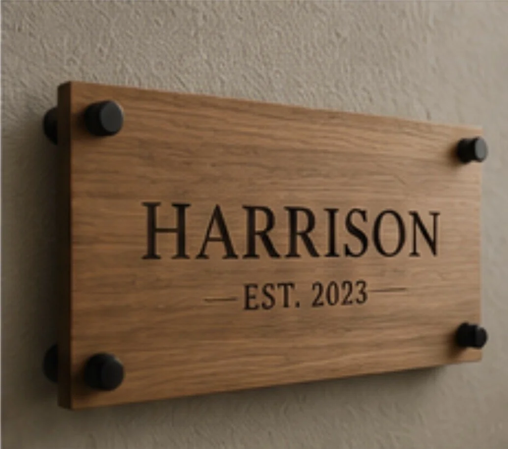 Wooden sign with the name Harris and the text EST. 2023, mounted on a wall.