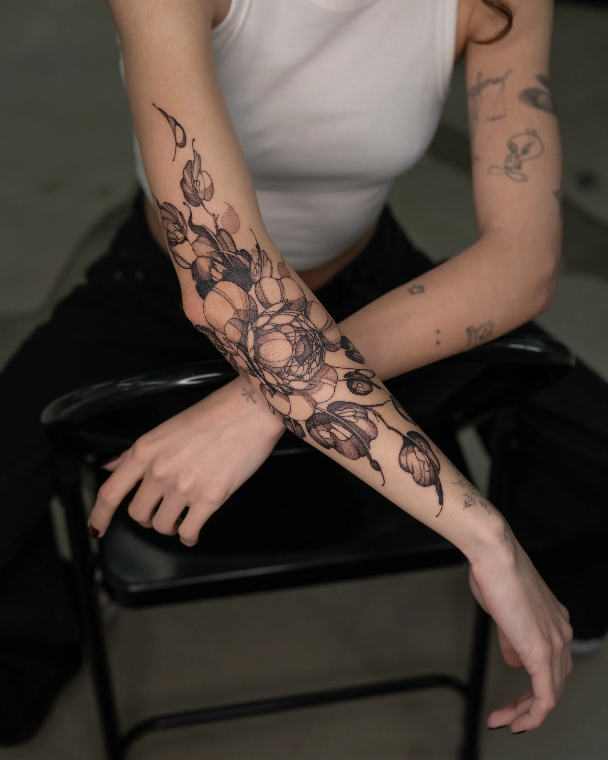 Fine-line floral, botanical peony tattoo done in Manchester, UK.