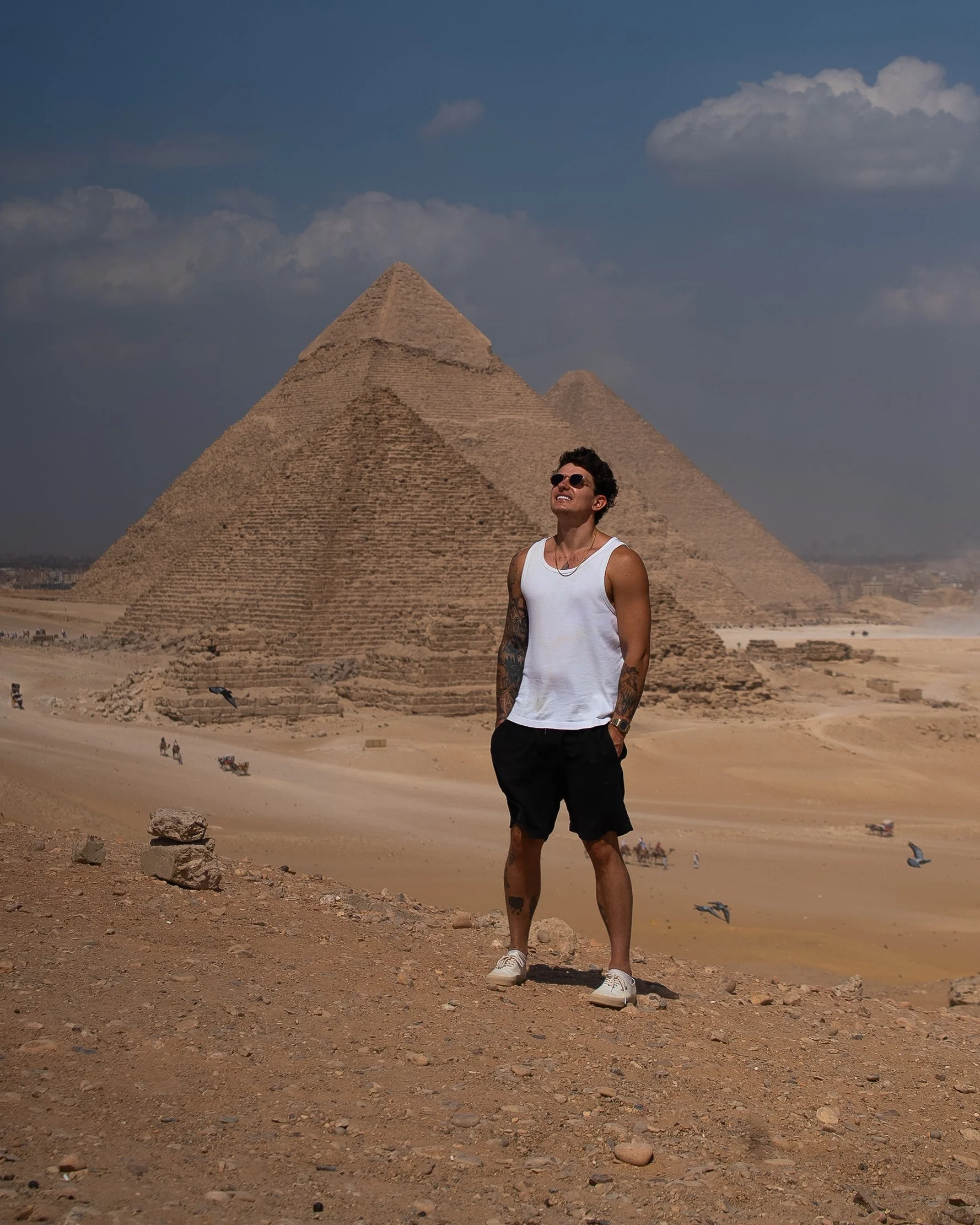 Bogdan Kosinov standing in front of the pyramids at Giza, Egypt, during daytime.