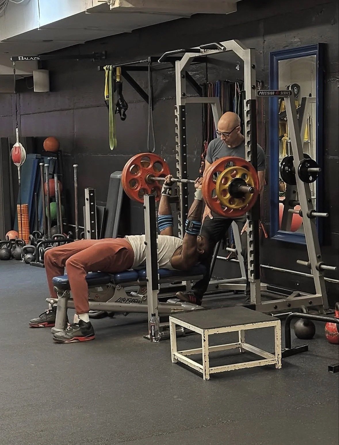 the live well company gym, man working out with a private personal trainer