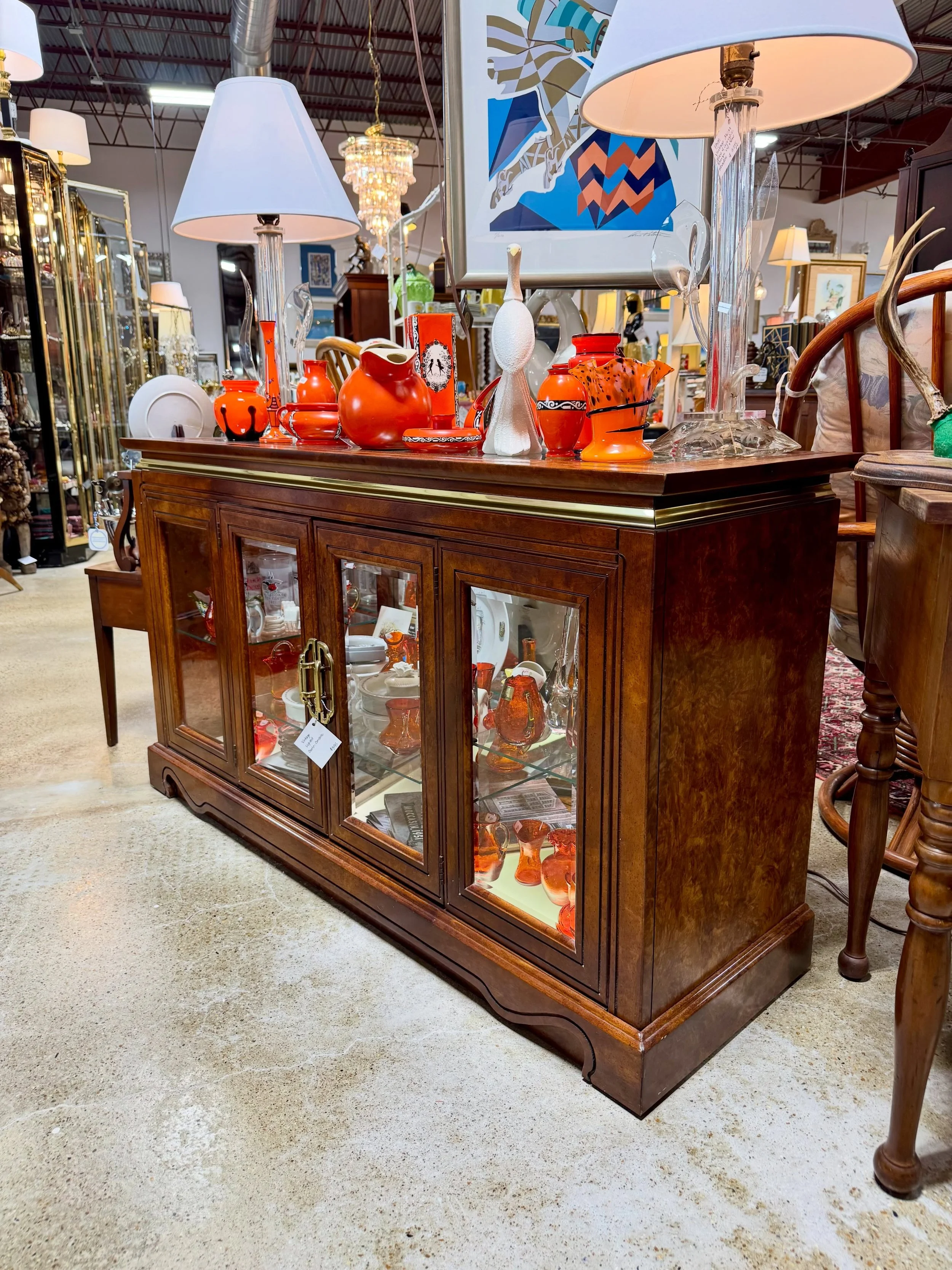 A fun and colorful corner of the store 🏵️

Vintage lighted curio-console stacked with orange art glass &mdash; let us know if you&rsquo;d like more information about any of these pieces.

#VintageFurniture #ArtGlass #CircaChattanooga