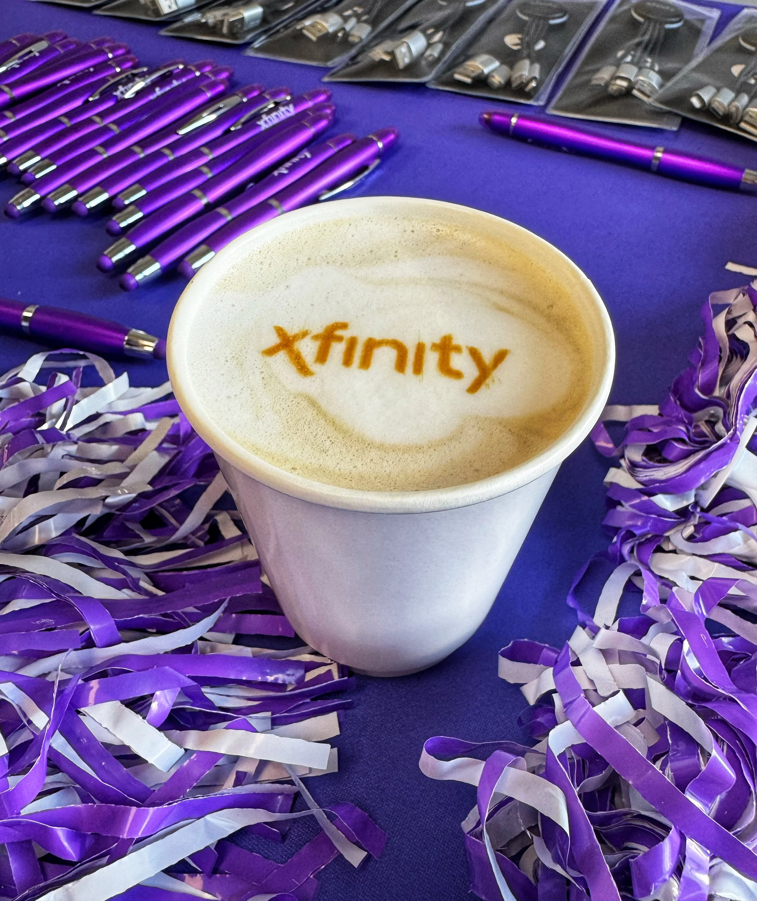 Custom Xfinity logo printed on latte foam by Old City Coffee Cart using Ripple machine at a Knoxville corporate event.