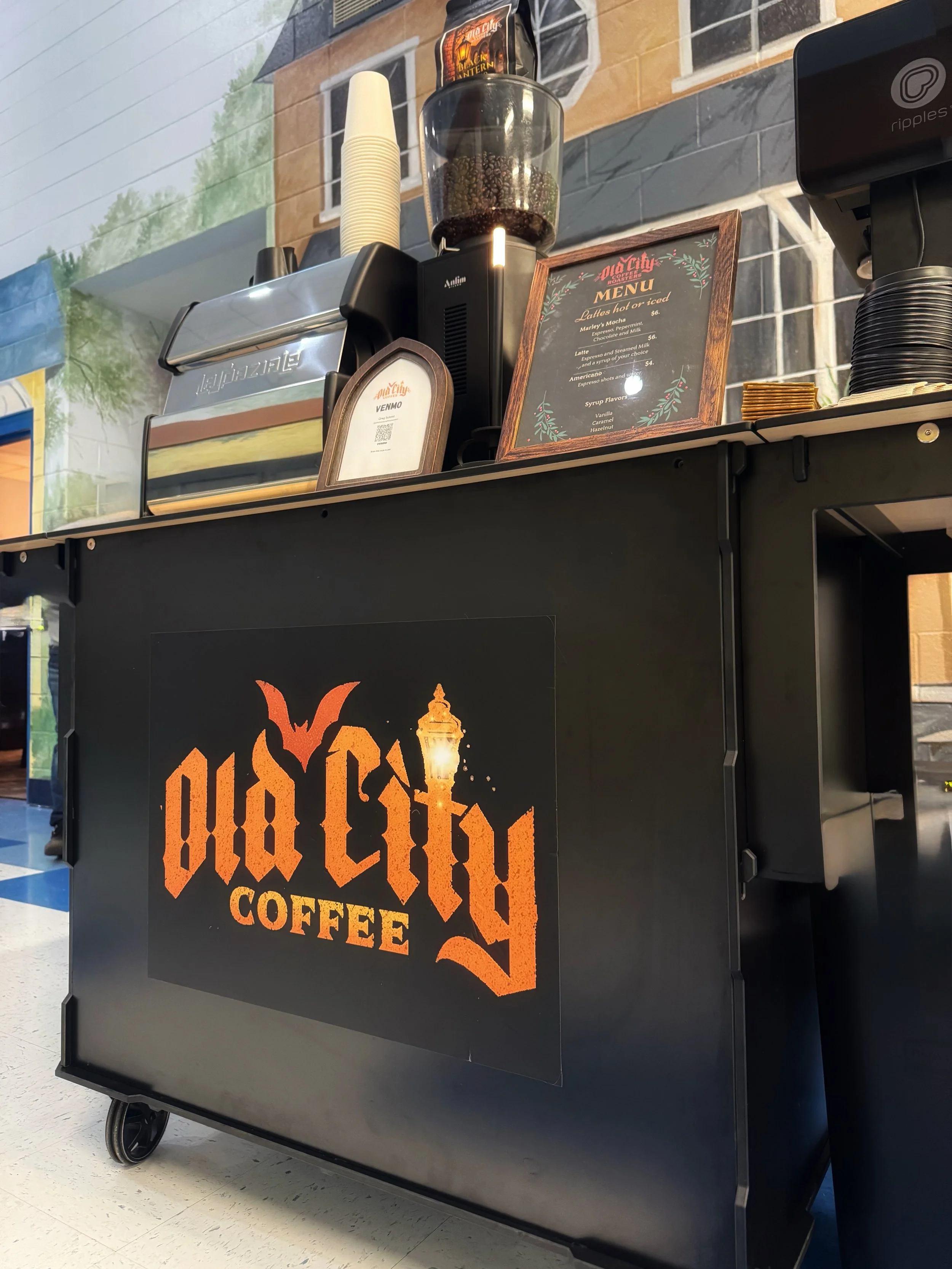 Old City Coffee Cart mobile espresso cart in Knoxville, Tennessee, set up for event coffee catering with specialty espresso equipment and branded menu.