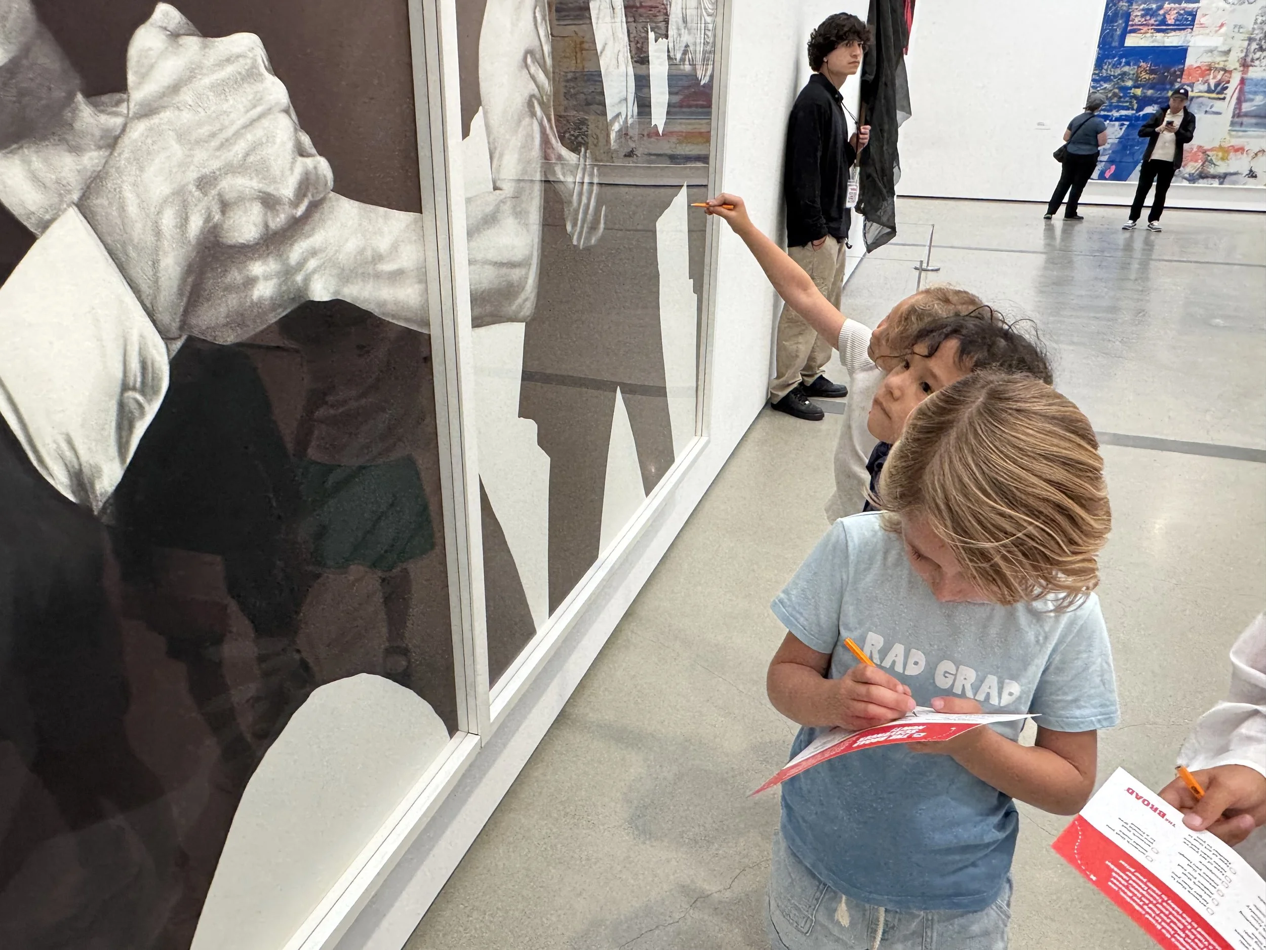 Girl writing something down at an art museum