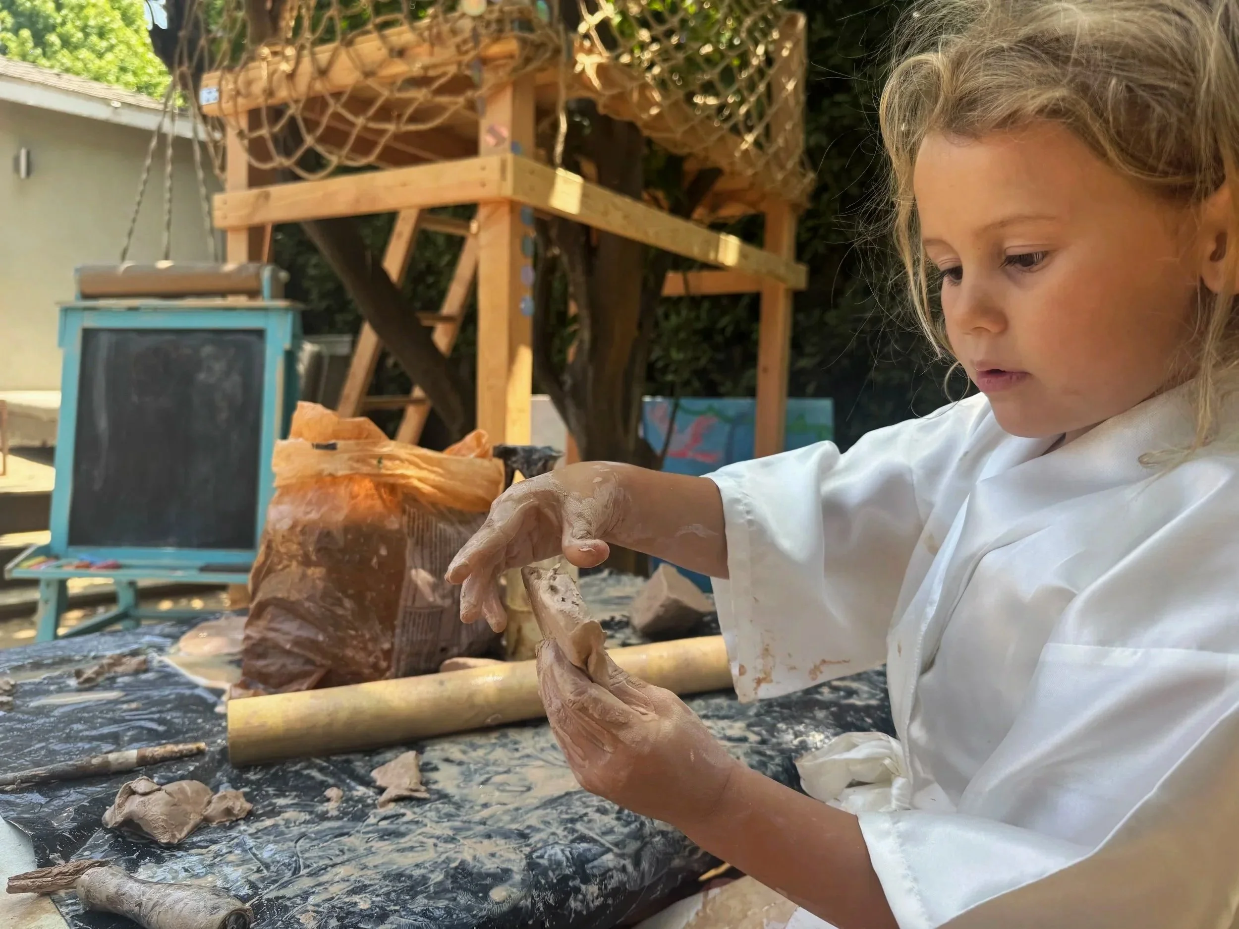 young girl playing with clay