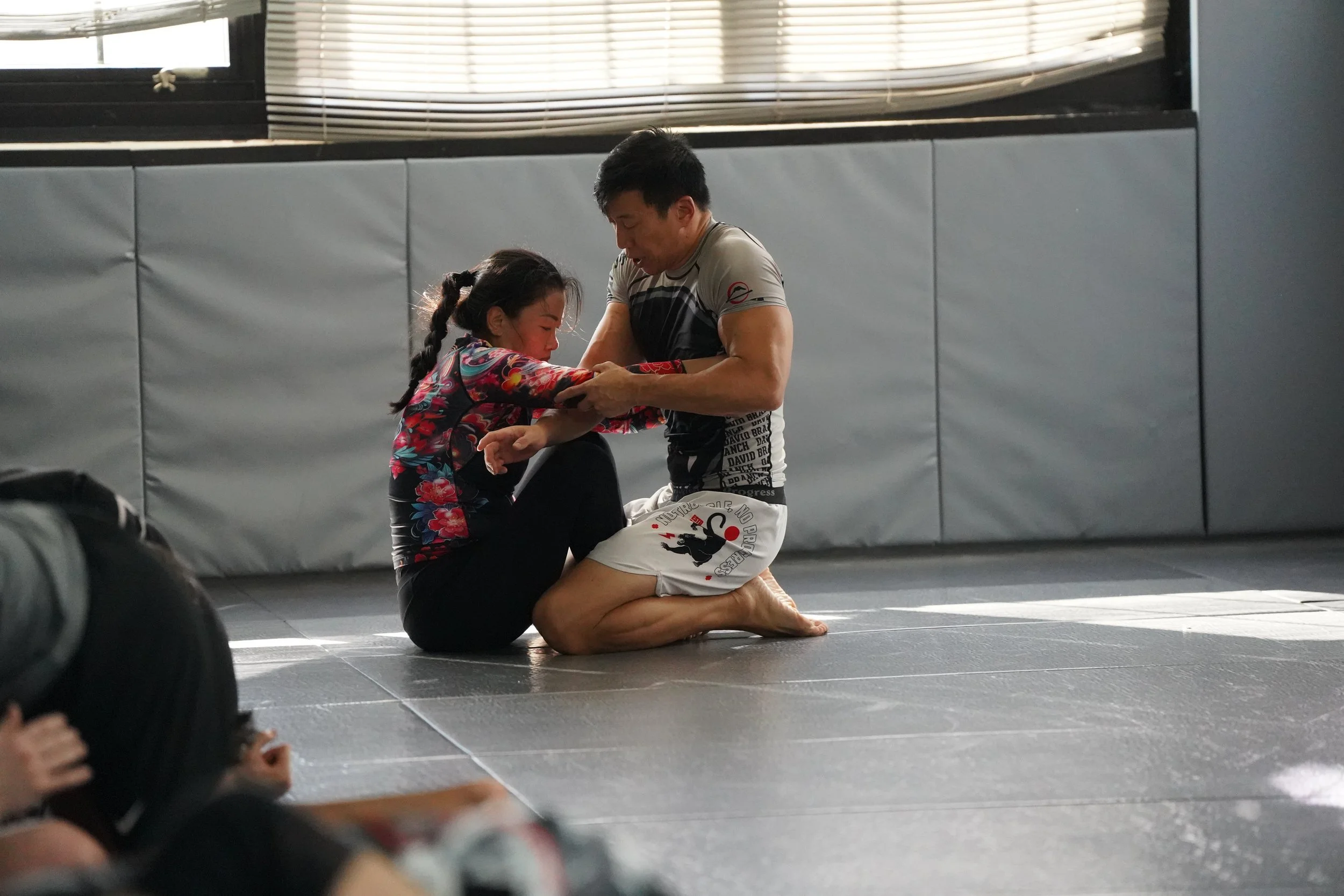 Man and woman training no gi Brazilian Jiu Jitsu in Montville NJ at David Branch Jiu Jitsu