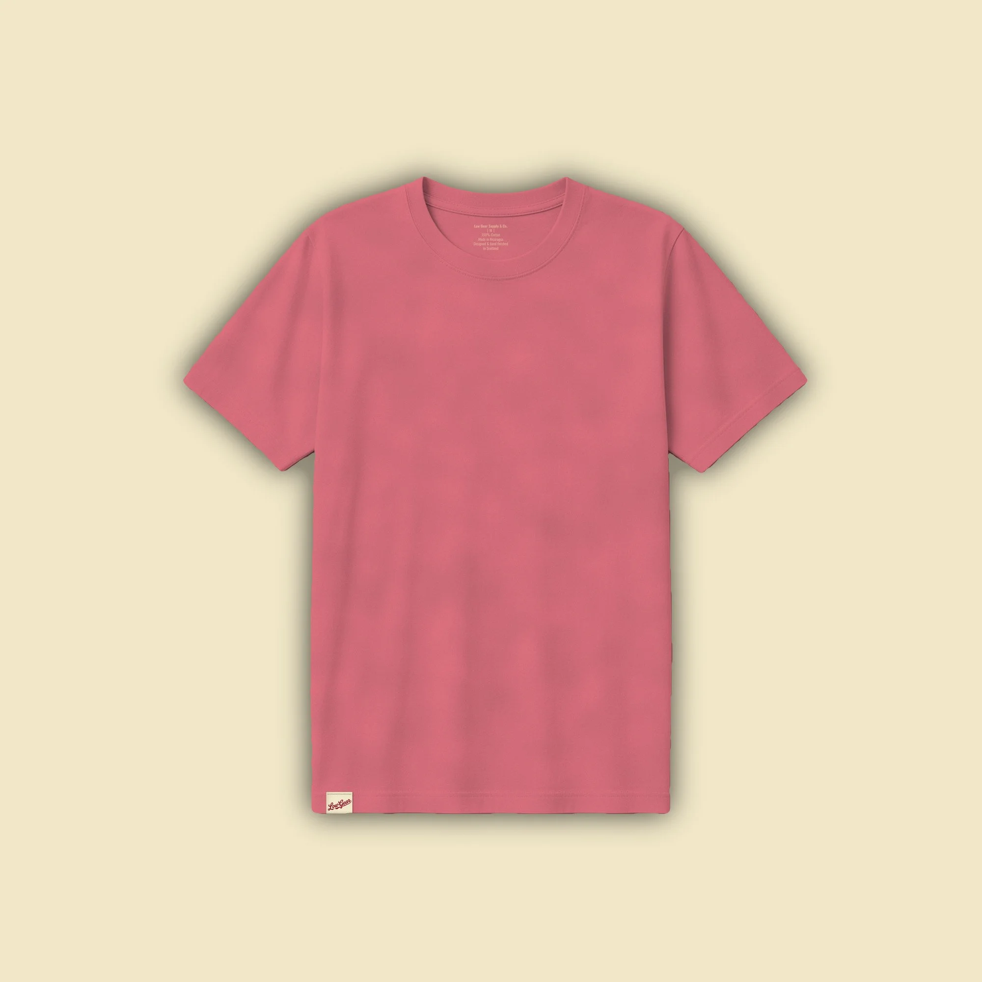 Graft Tee in washed red, front view with a woven Low Gear tag folded over the hem