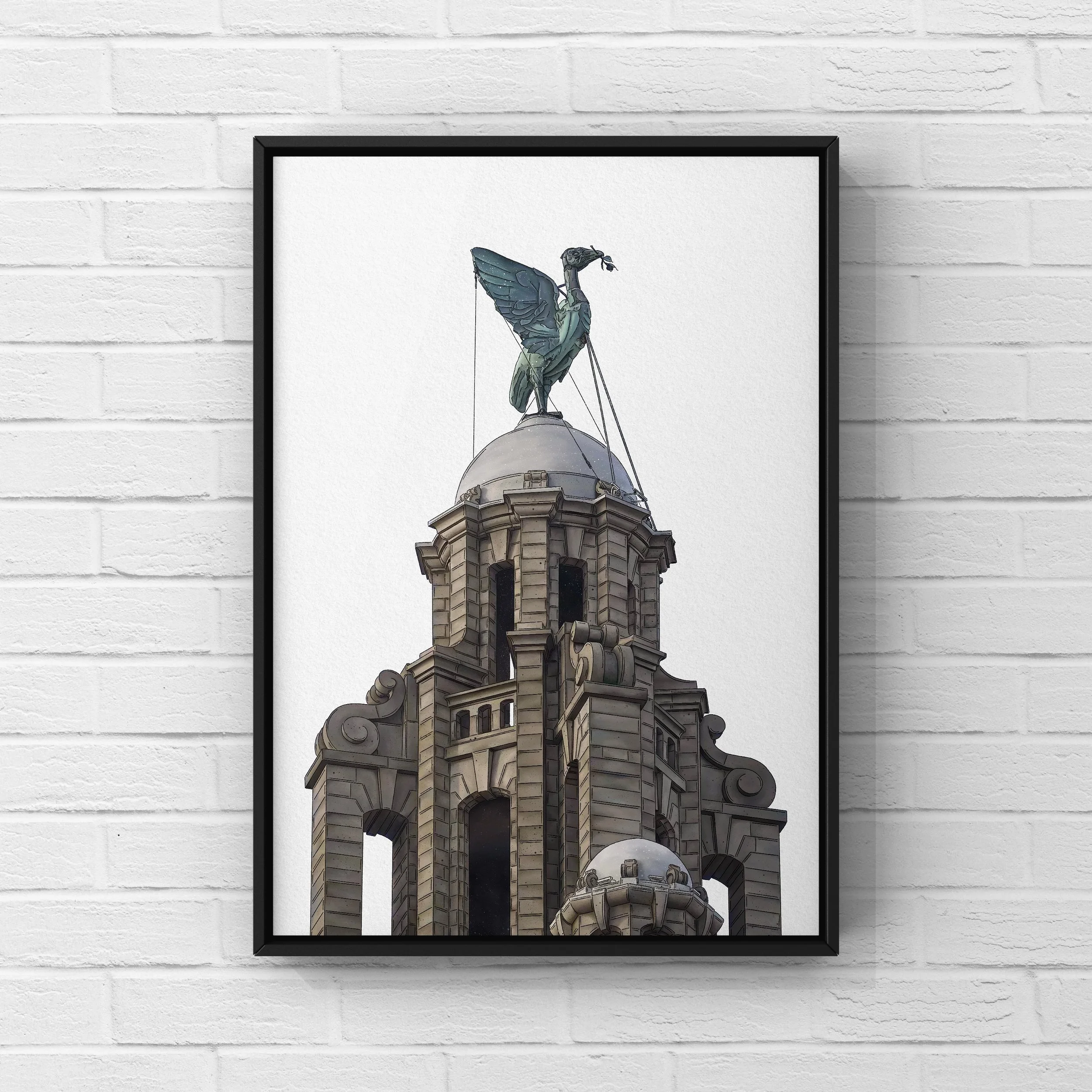 Framed artwork of a building with a clock tower topped by a sculpture of a bird with wings spread, perched on a dome, against a white brick wall.